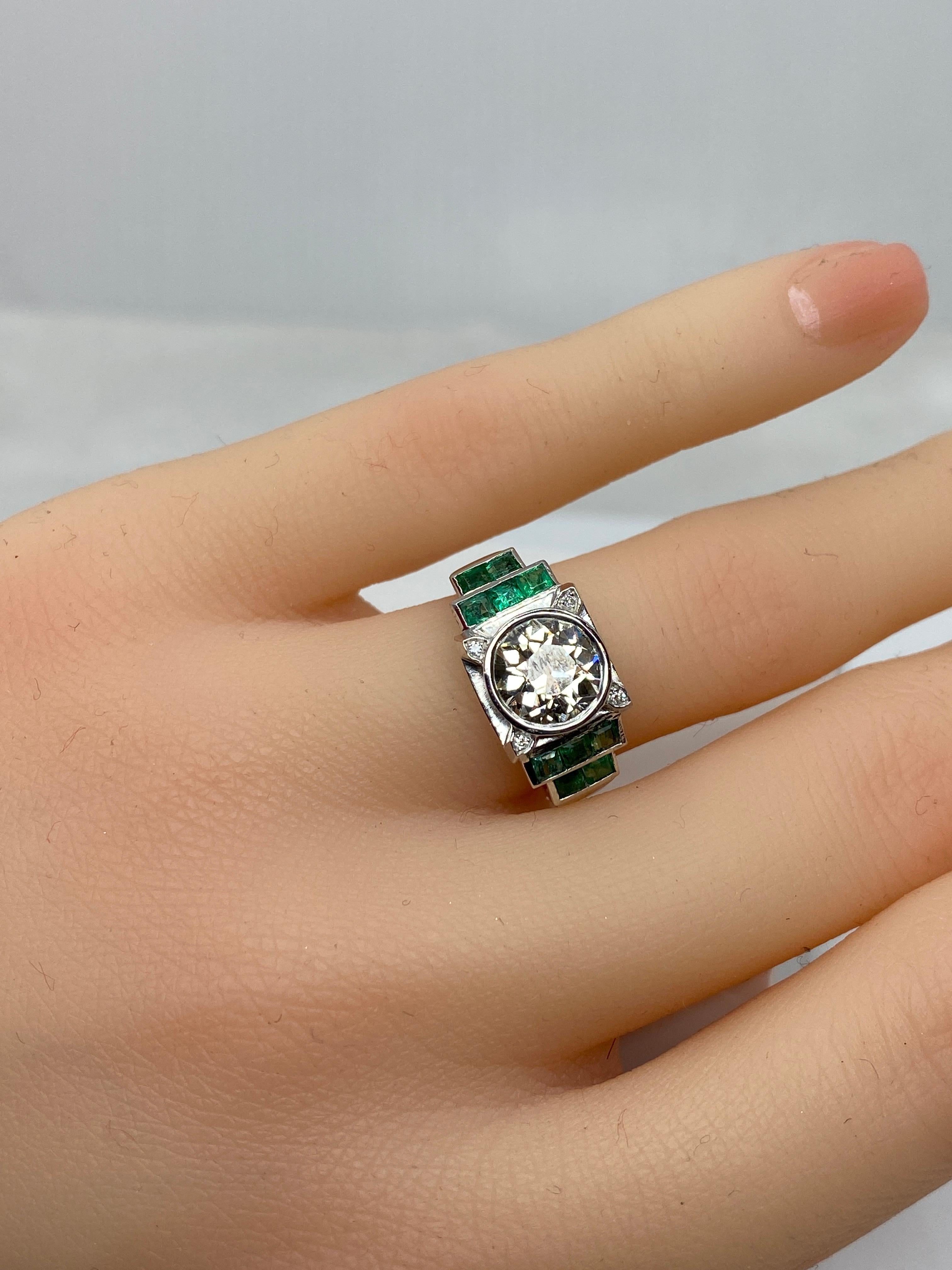 Emerald Cut Platinium Engagement Ring Set with a 1.55 Carat Diamond Backed by Emeralds, 1900 For Sale