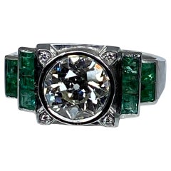 Platinium Engagement Ring Set with a 1.55 Carat Diamond Backed by Emeralds, 1900