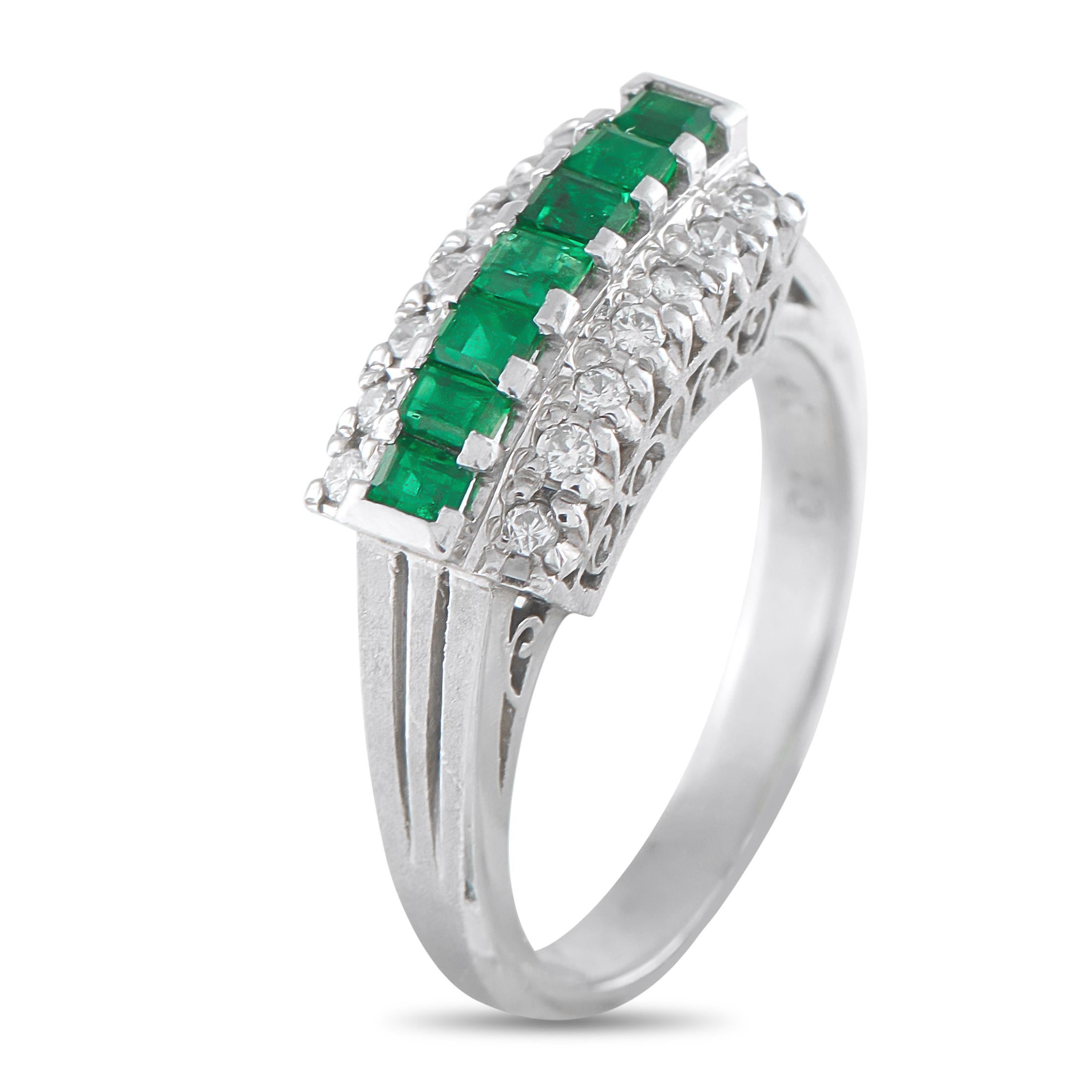 This classically elegant ring will continually capture your imagination. A single row of Emeralds totaling 0.41 carats add a touch of color to the center of the design, while Diamonds totaling 0.13 carats further elevate the intricate Platinum