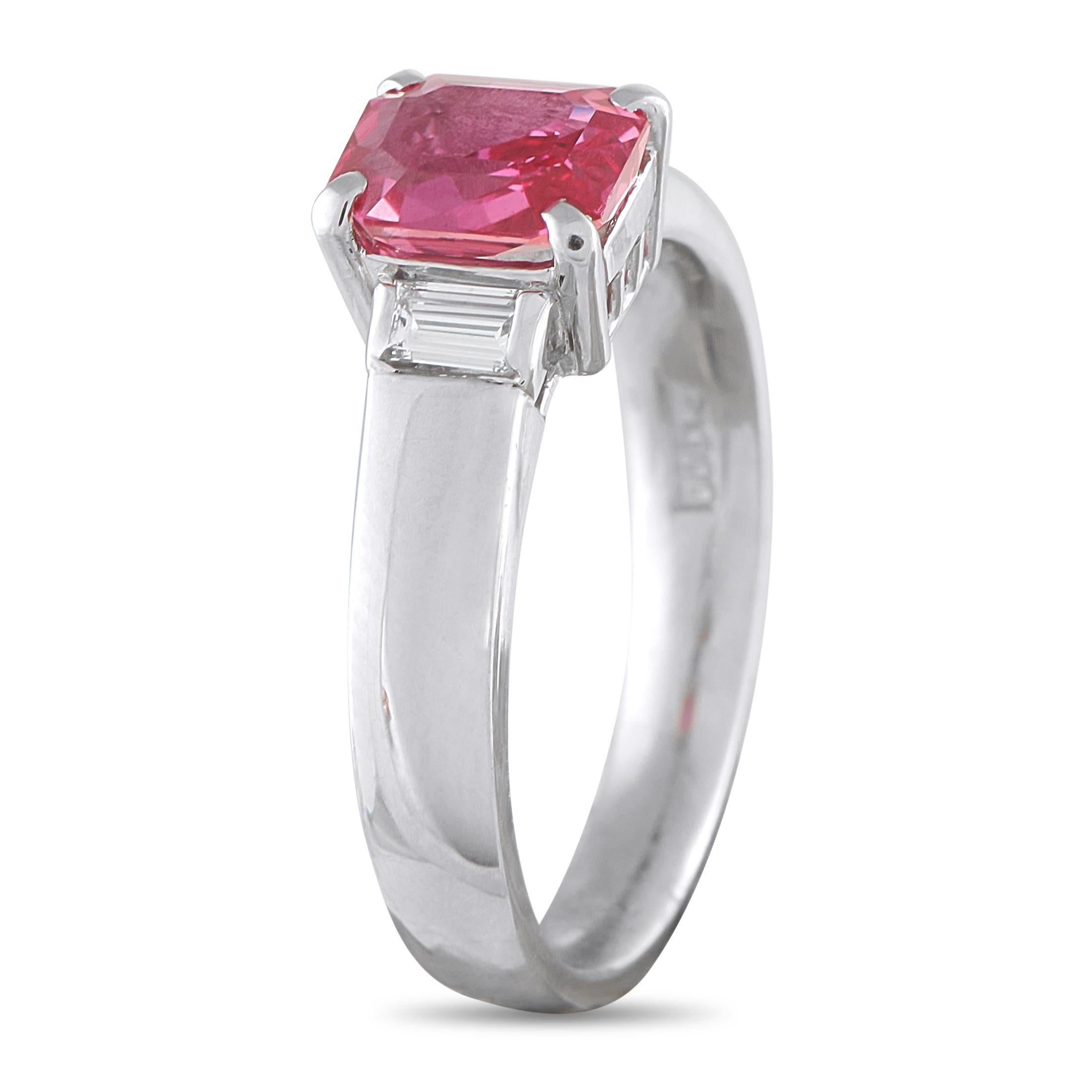 Clean lines define the elegant look of this three-stone platinum ring. It features a 1.45-carat radiant-cut ruby secured by four corner prongs for both protection and symmetry. The ruby's rectangular form is framed by baguette diamonds set in half