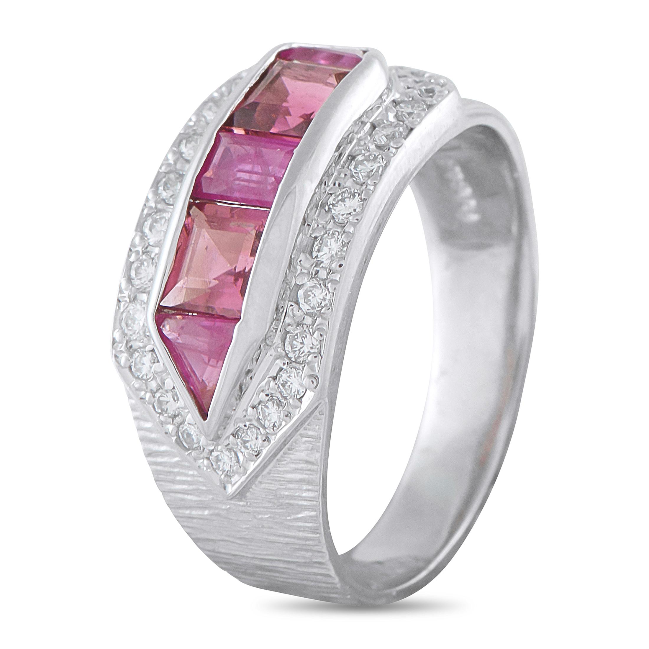 Dramatic in design, sophisticated in texture. This platinum ring features a central channel set with a radiant row of vibrant pink sapphires. The channel ends are distinctly pointed, creating a dynamic arrow-like flow across the finger. This bold