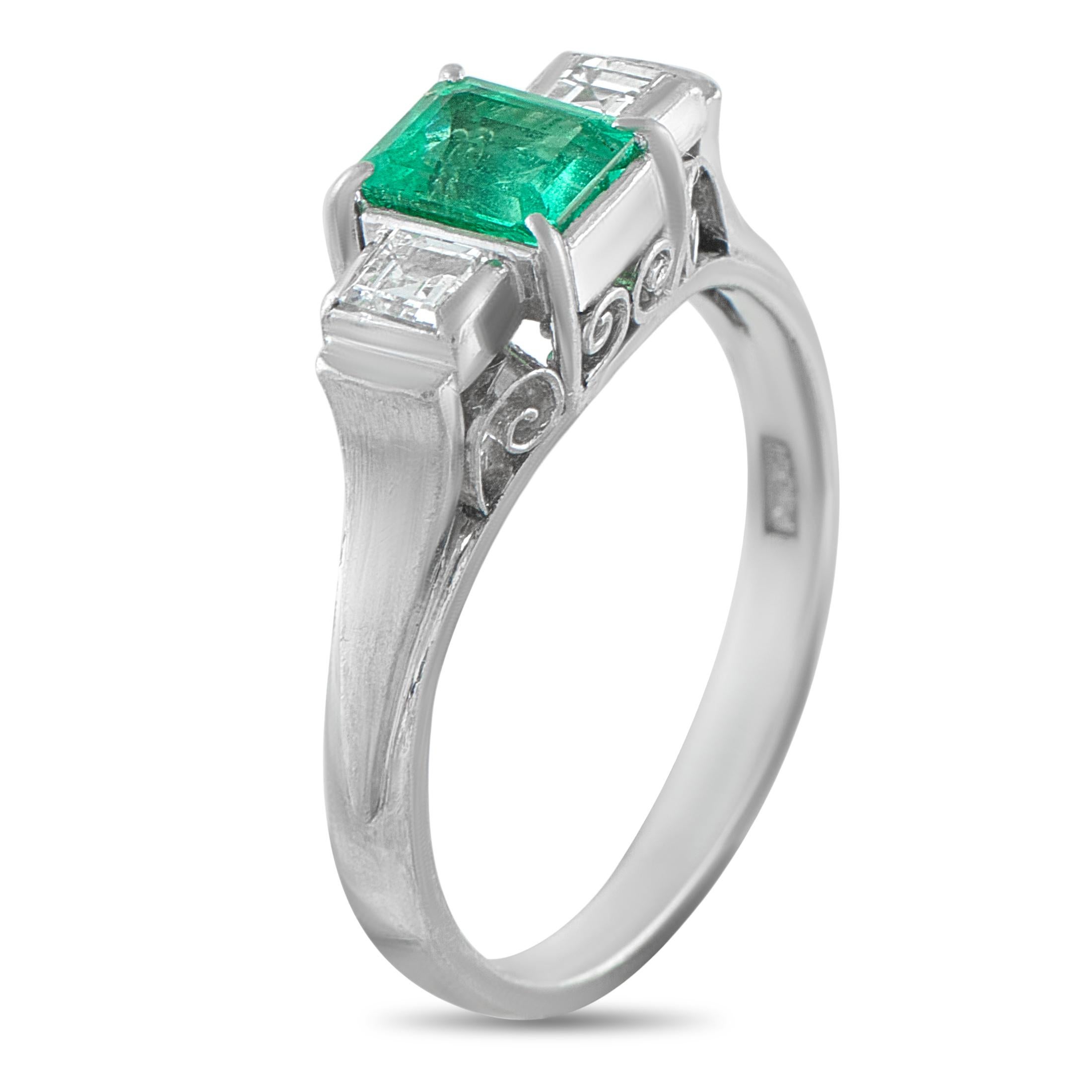 This three-stone ring is a classically elegant piece that will continually impress. A 0.67 carat Emerald adds a stylish pop of color to the center, while Diamonds totaling 0.24 carats provide the perfect finishing touch. This pieces Platinum setting