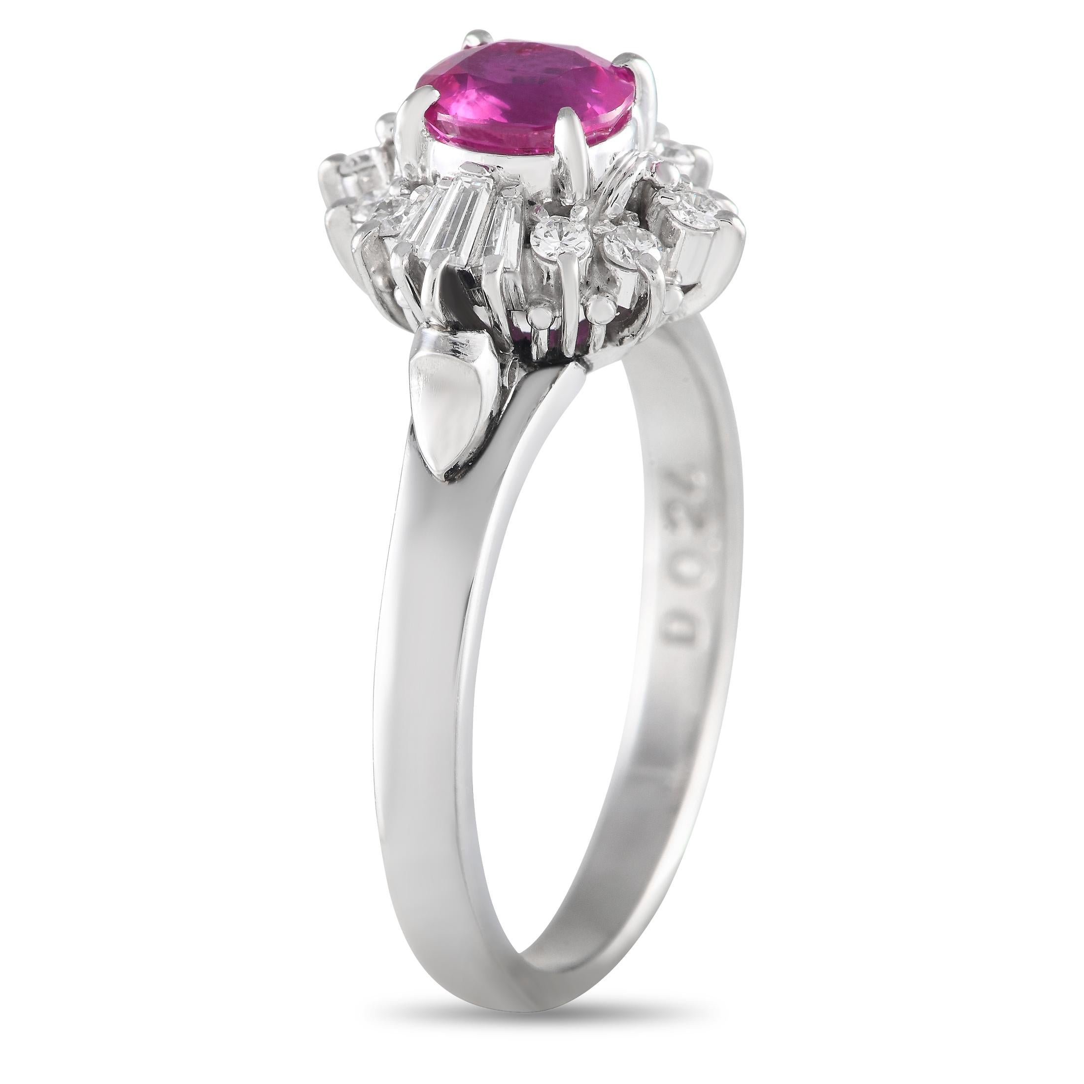 Dreamy and distinctly feminine. This platinum ring features a modestly sized but stunning 0.69 ct ruby framed by the icy white sparkle of round and baguette diamonds. The ring's top dimensions measure 17mm by 11mm.Offered in estate condition, this