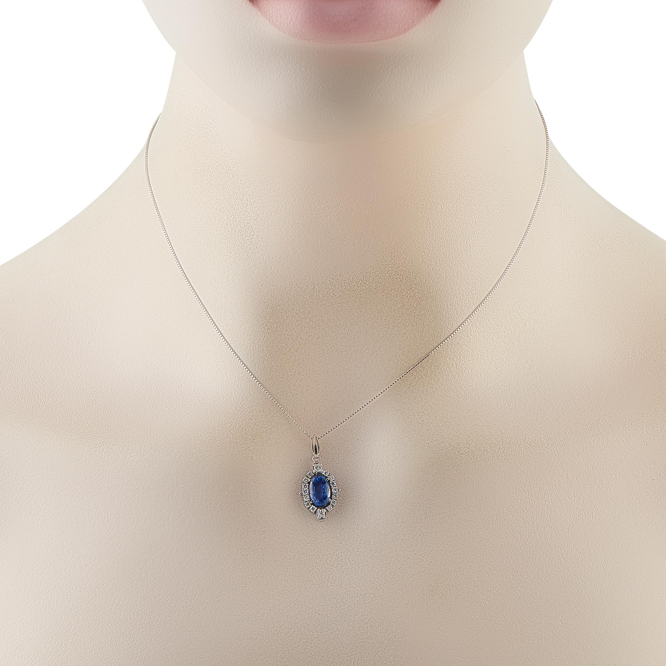 A modern heirloom. This necklace features a 1.93-carat oval sapphire, its deep blue hue enhanced by the fire of a diamond halo in a negative space setting. The slight separation between the blue center stone and its halo maximizes the optical