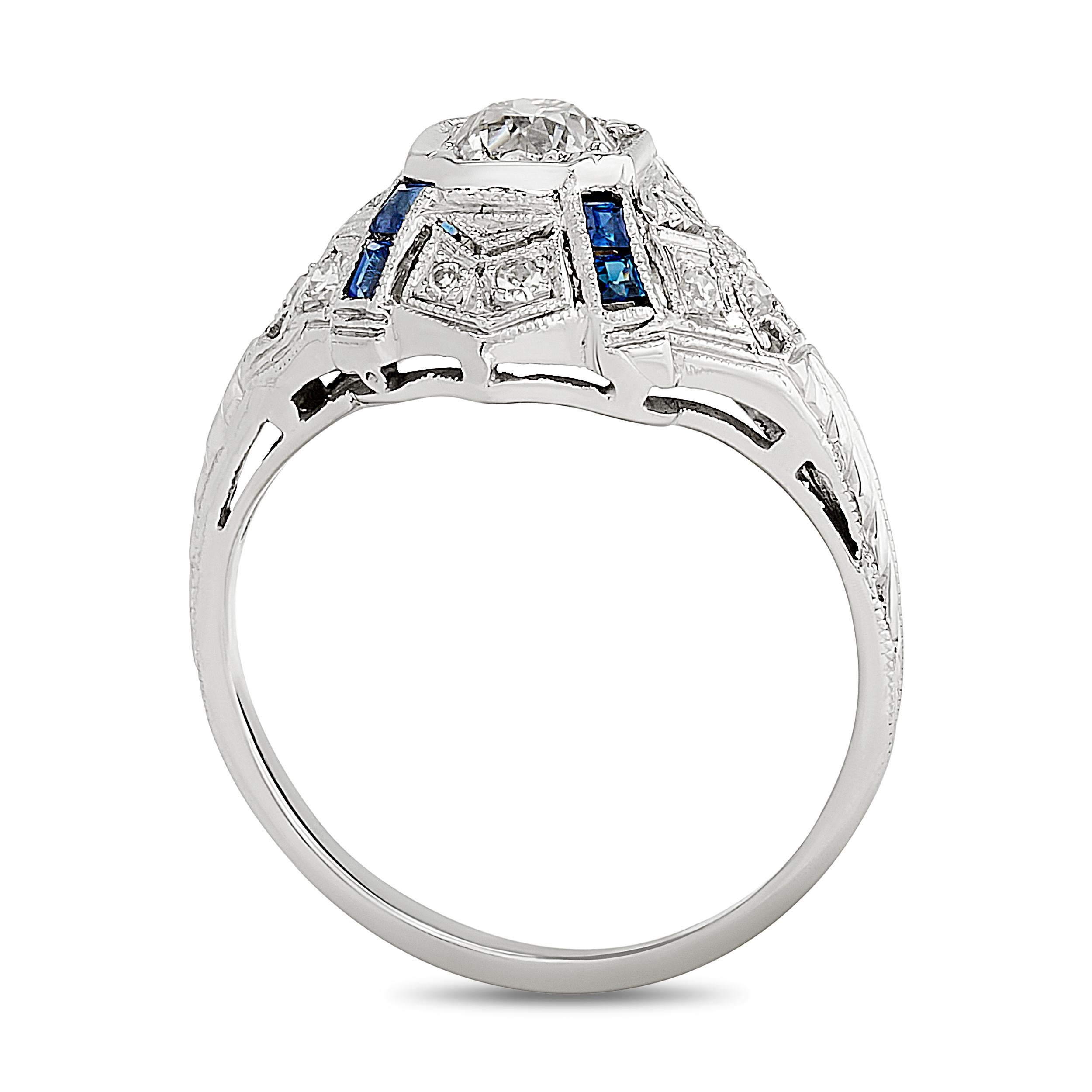 This ring features a central diamond set in a geometric, octagonal setting, accented with synthetic sapphires and smaller diamonds, all crafted in platinum with intricate milgrain detailing and hand-engraved designs.

Center Round Diamond -