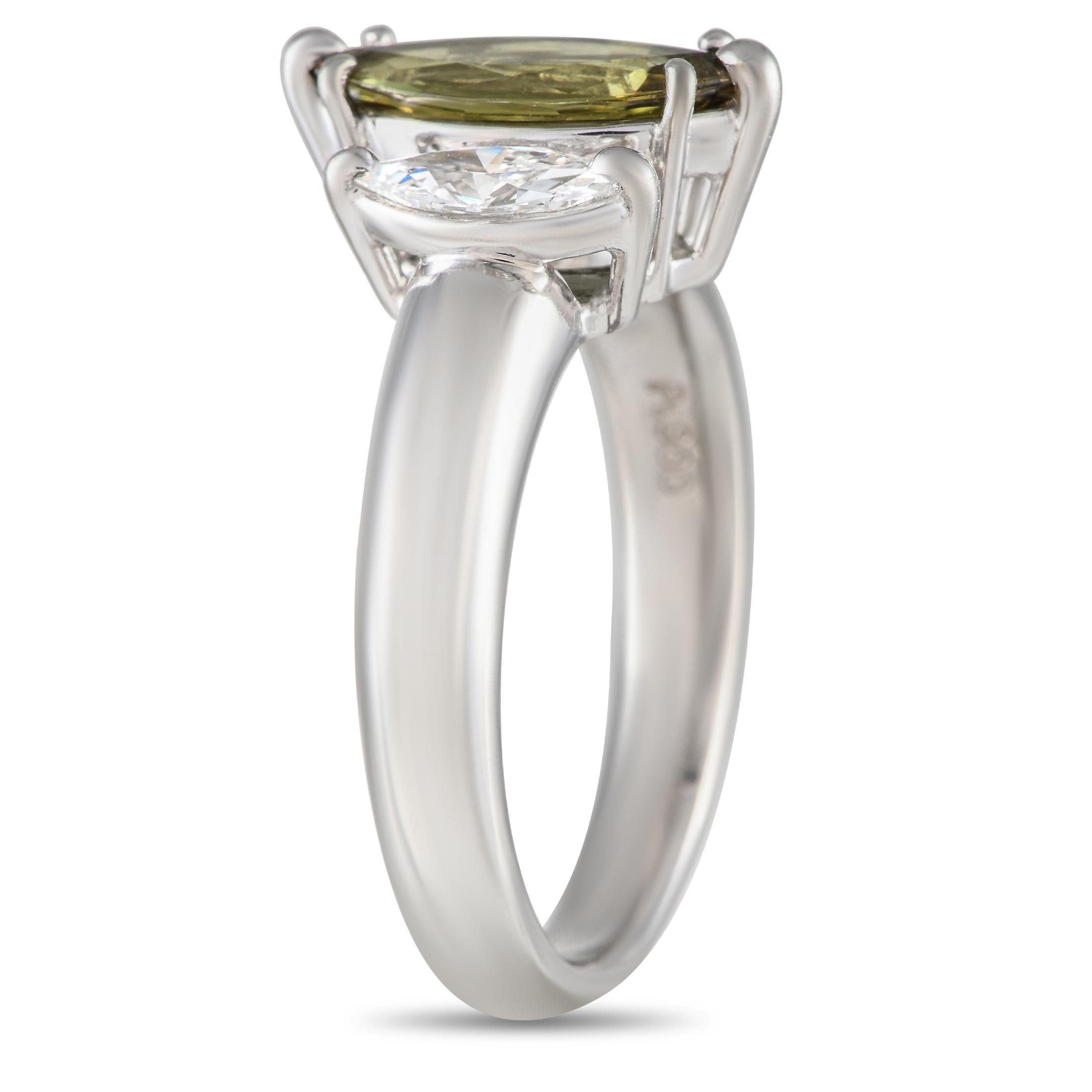 A trio of marquise cut gemstones make a statement at the center of this exquisite ring. At the center, a 1.28 carat Sphene gemstone adds a subtle pop of color. The surrounding Diamonds totaling 0.52 carats add a touch of sparkle to the minimalist