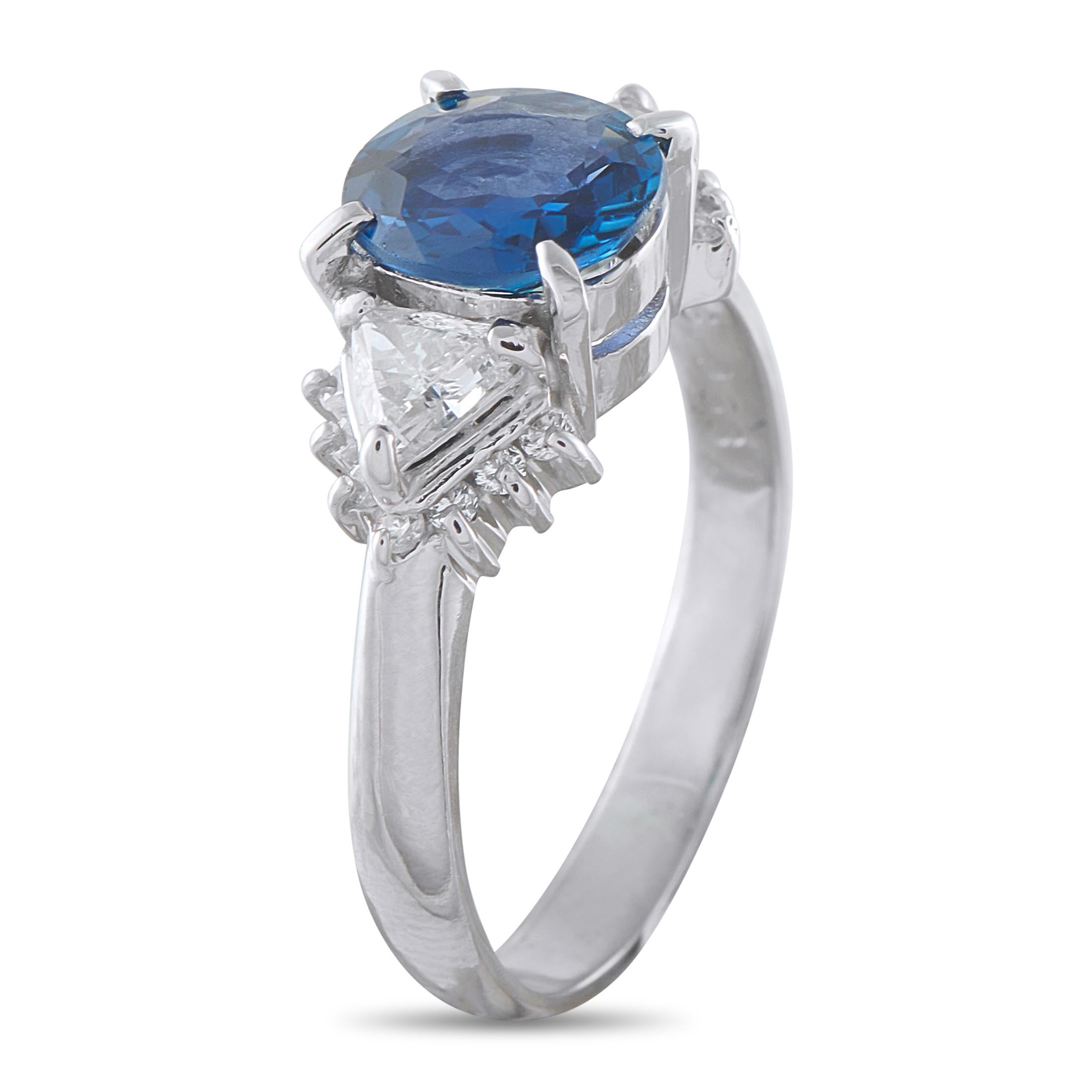 The beauty of this ring begins with its powerful geometry, offering a sharp deviation from the conventional. At its center lies a 1.58-carat sapphire set on four minimal prongs. Two trillion-cut diamonds flank the sapphire like finely crafted