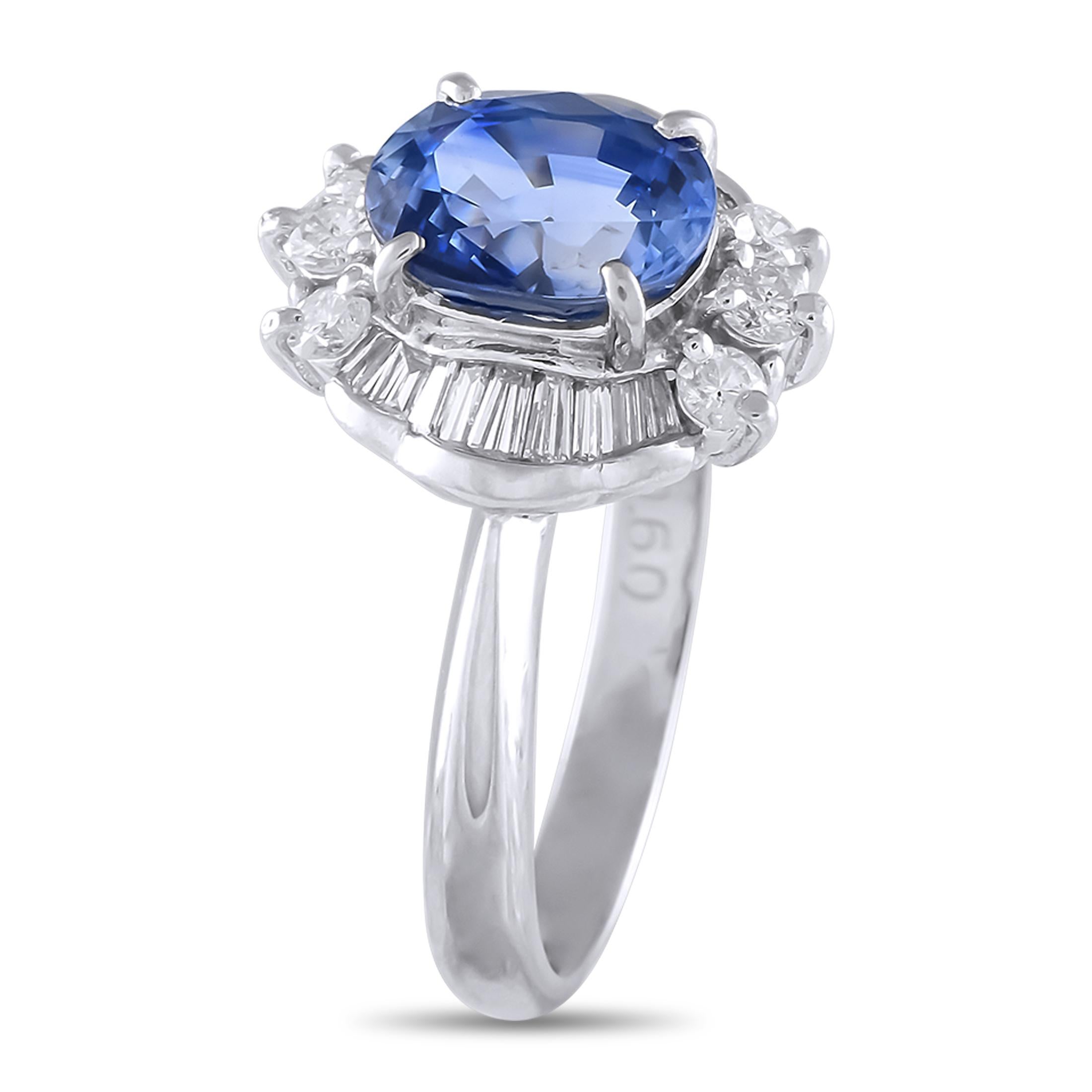 A true treasure for Art Deco jewelry lovers. This stunning platinum ring features a captivating 2.25 carat oval sapphire center stone. A symmetrical layout of prong-set round diamonds and invisible set tapered baguette diamonds frames the blue gem.