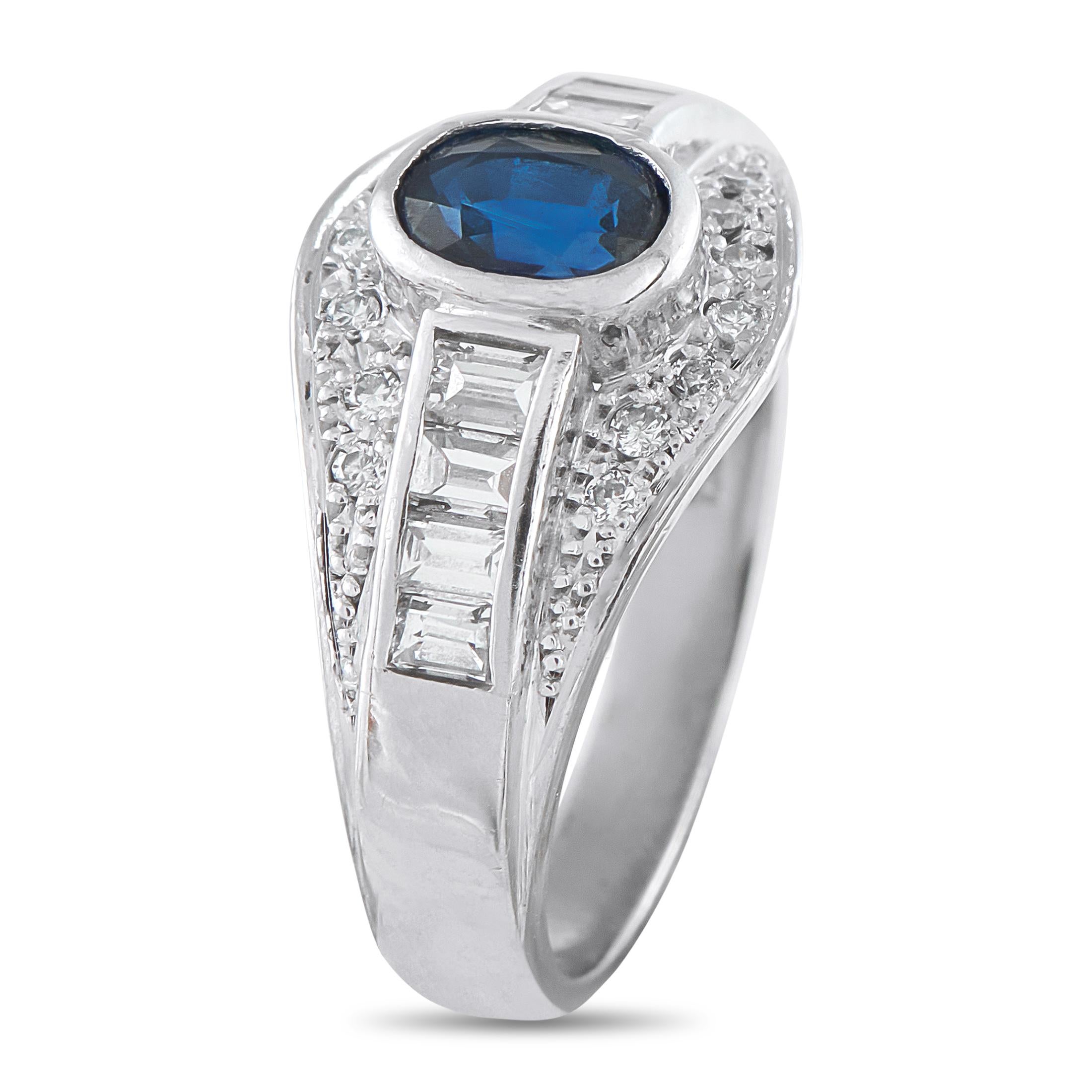 In this piece, a 1.08-carat oval sapphire sits flush on the center, letting its vivid color take full prominence. A channel of invisibly set baguette diamonds flanks the sapphire, radiating a mirror-like brilliance. A wave of pav-set round diamonds