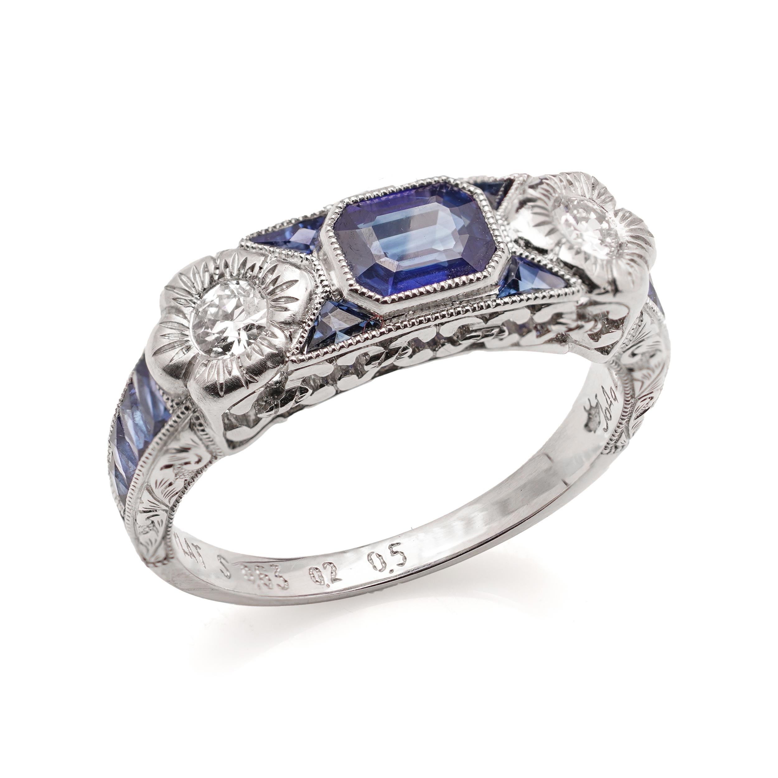 Platinum 0.63 carats of Emerald - cut Blue Sapphire ring, set with two round brilliant diamonds, baguette, and triangle-cut sapphires. 

Made in After 2000
Maker: JoAq 
X-Ray tested positive for .850 platinum purity. 

Dimensions - 
Finger Size (UK)