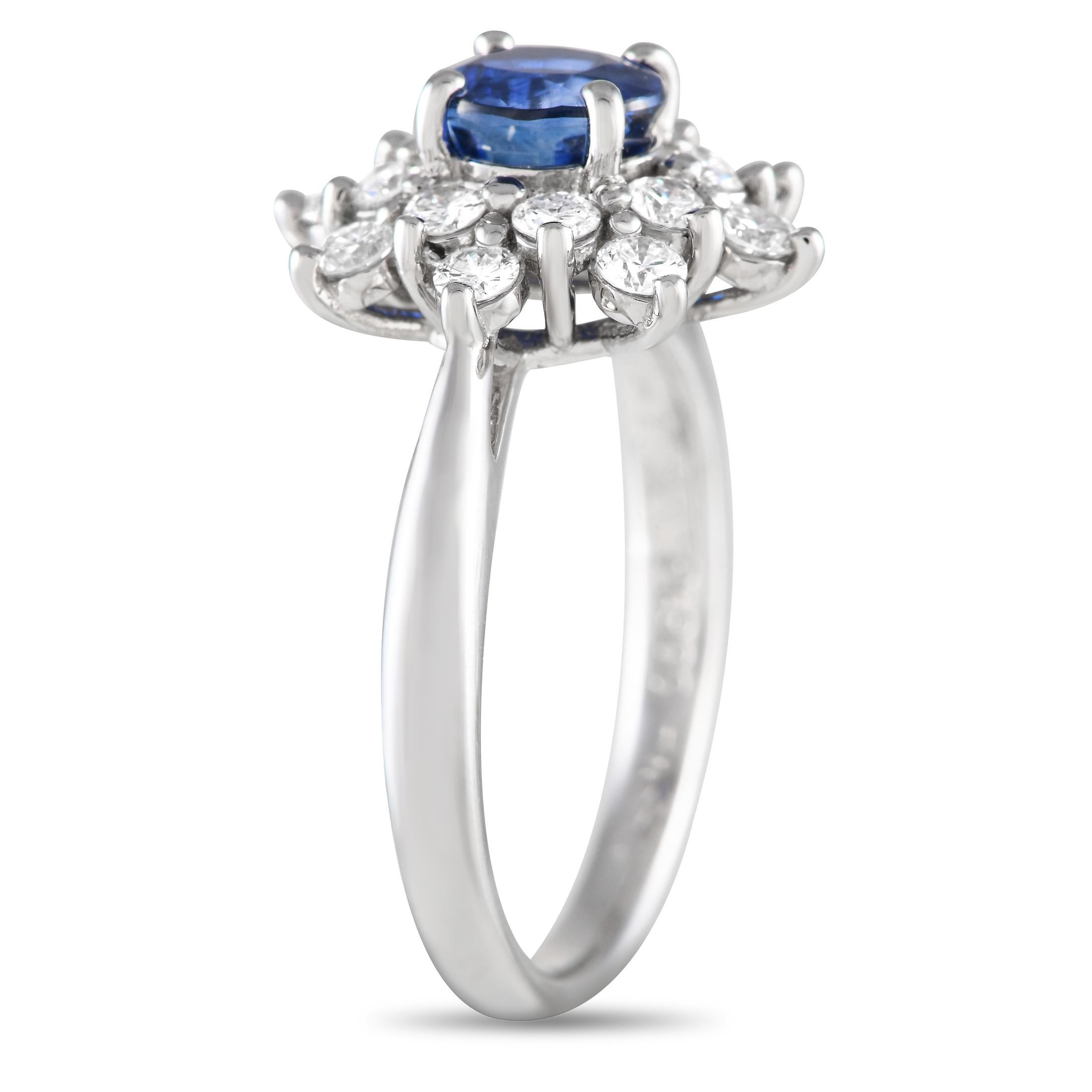This diamond and blue sapphire ring makes a stunning symbol of love. It is crafted in everlasting platinum and topped with a gorgeous 1.20 ct round sapphire. Surrounding the dazzling blue gem is a starburst halo of round diamonds. The ring's top