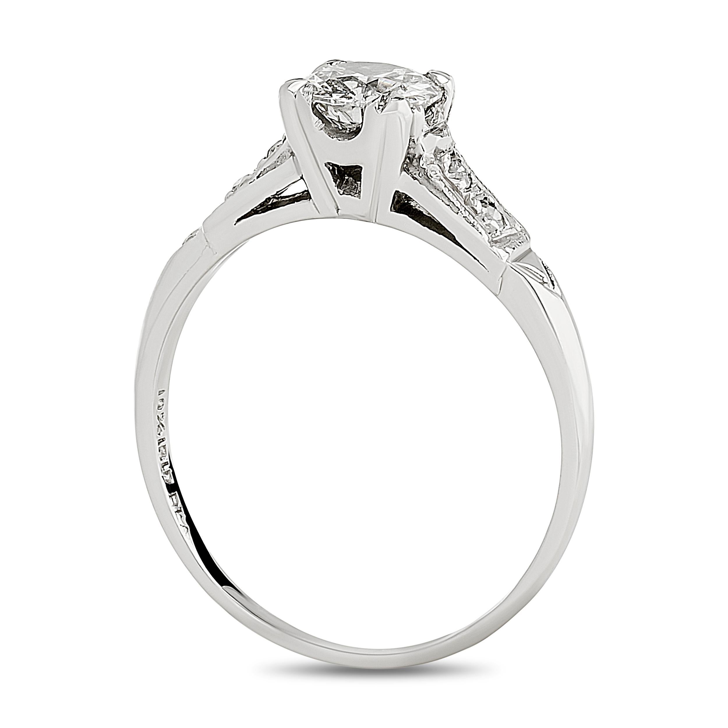 This platinum ring showcases a classic old European cut diamond held in a square, illusion-style setting, flanked by two smaller diamonds channel-set within geometric, stepped shoulders, exemplifying elegance.

Center Old European Cut Diamond -