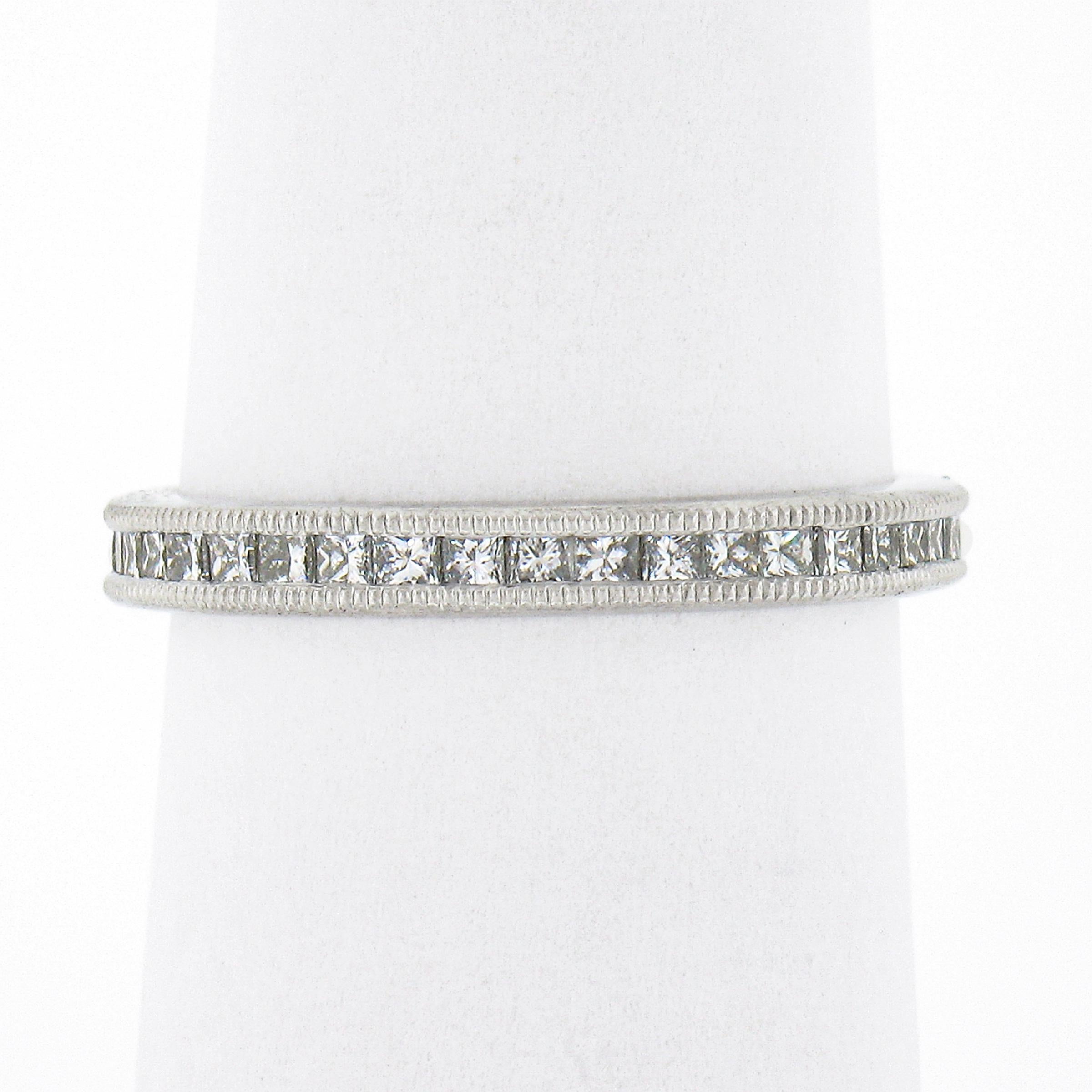 This gorgeous diamond eternity band ring was crafted from solid platinum and features a simple channel setting that carries 40 princess cut diamonds throughout the entire band. These SUPER FINE quality diamonds show incredible brilliance with super