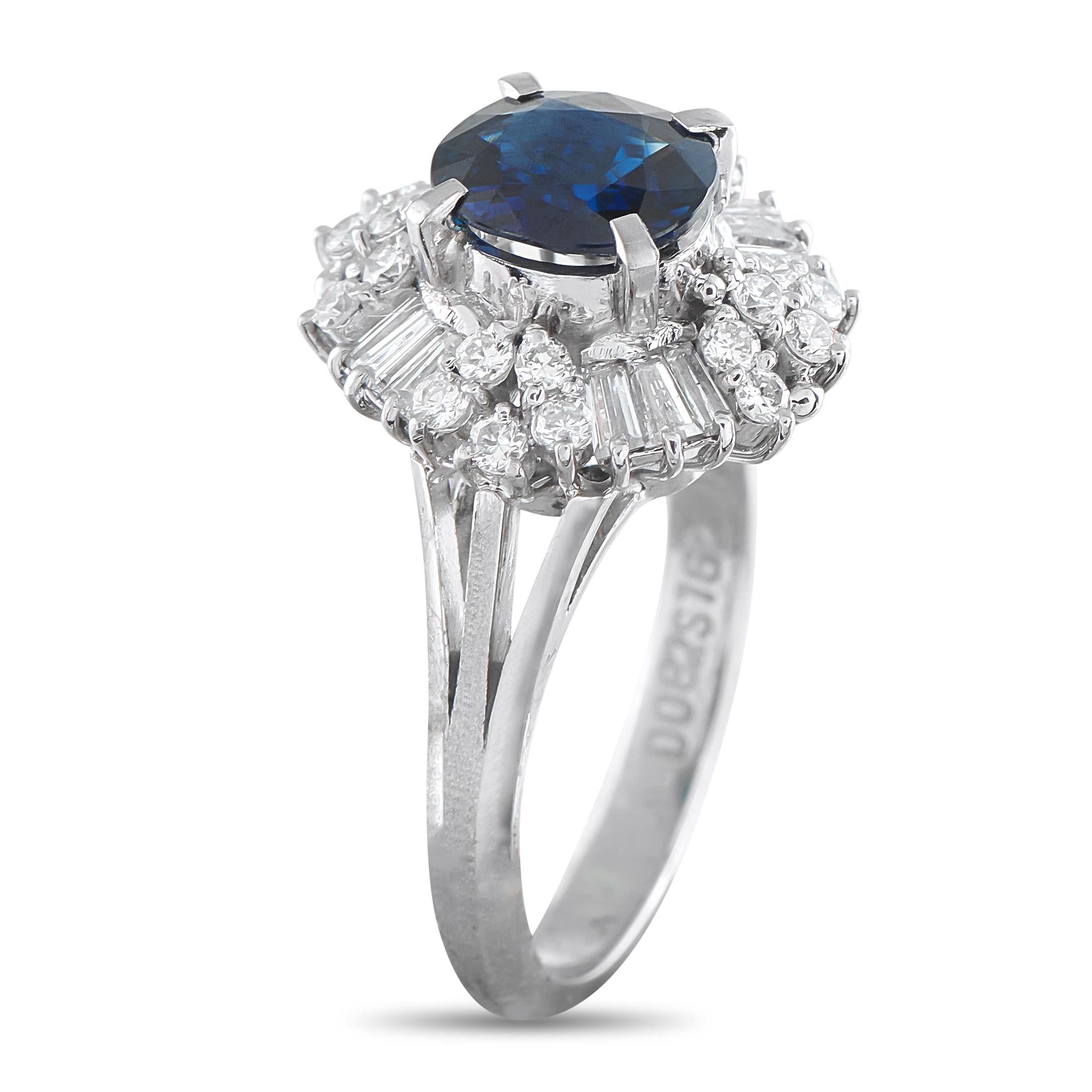 In this ring, the platinum shank rises into double split shoulders, lifting the 1.62-carat sapphire centerstone and diamond halo for maximum visibility and light play. The halo of diamonds alternates between clusters of round stones and trios of