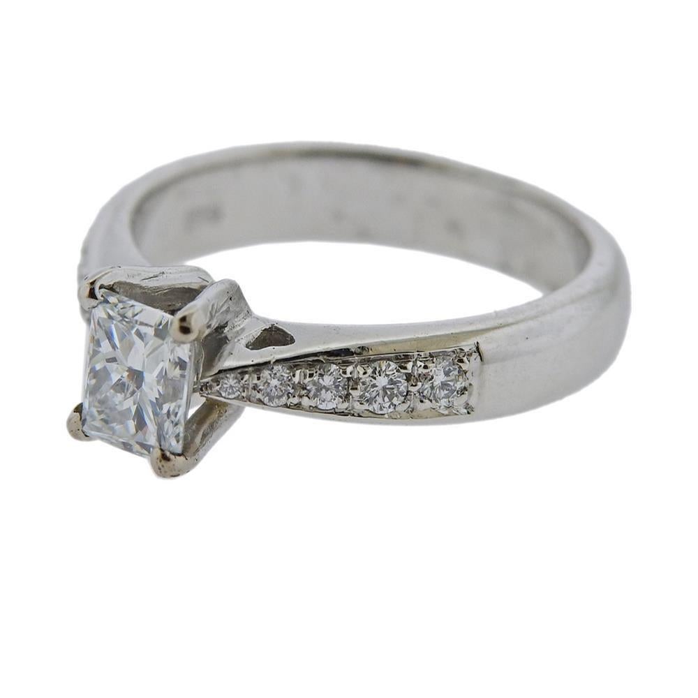 Platinum wedding ring. Set with center diamond approx. 0.83ct (approx. D color, VVS2 clarity) , surrounding diamonds approx. 10 setting diamonds . Measures - size 7, ring top is 6.3mm wide. Marked 950 Pt 1017 Al. Weight 7.2 grams.