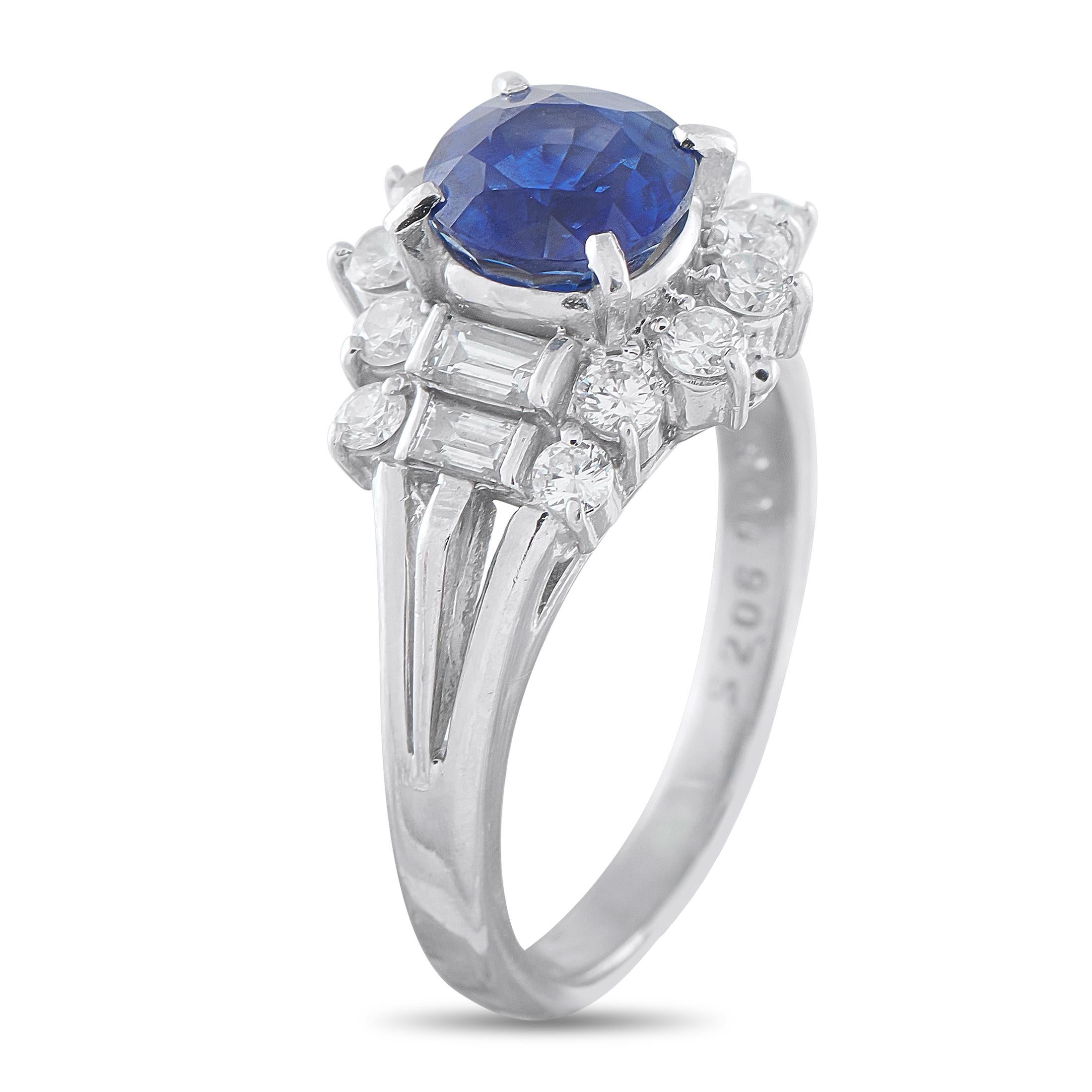 This ring carries the undeniable promise of an heirloom, beautifully crafted for the present. A 2.06-carat round sapphire commands attention at the center, set high on four prongs. It is flanked by a stepped arrangement of two crisp baguette