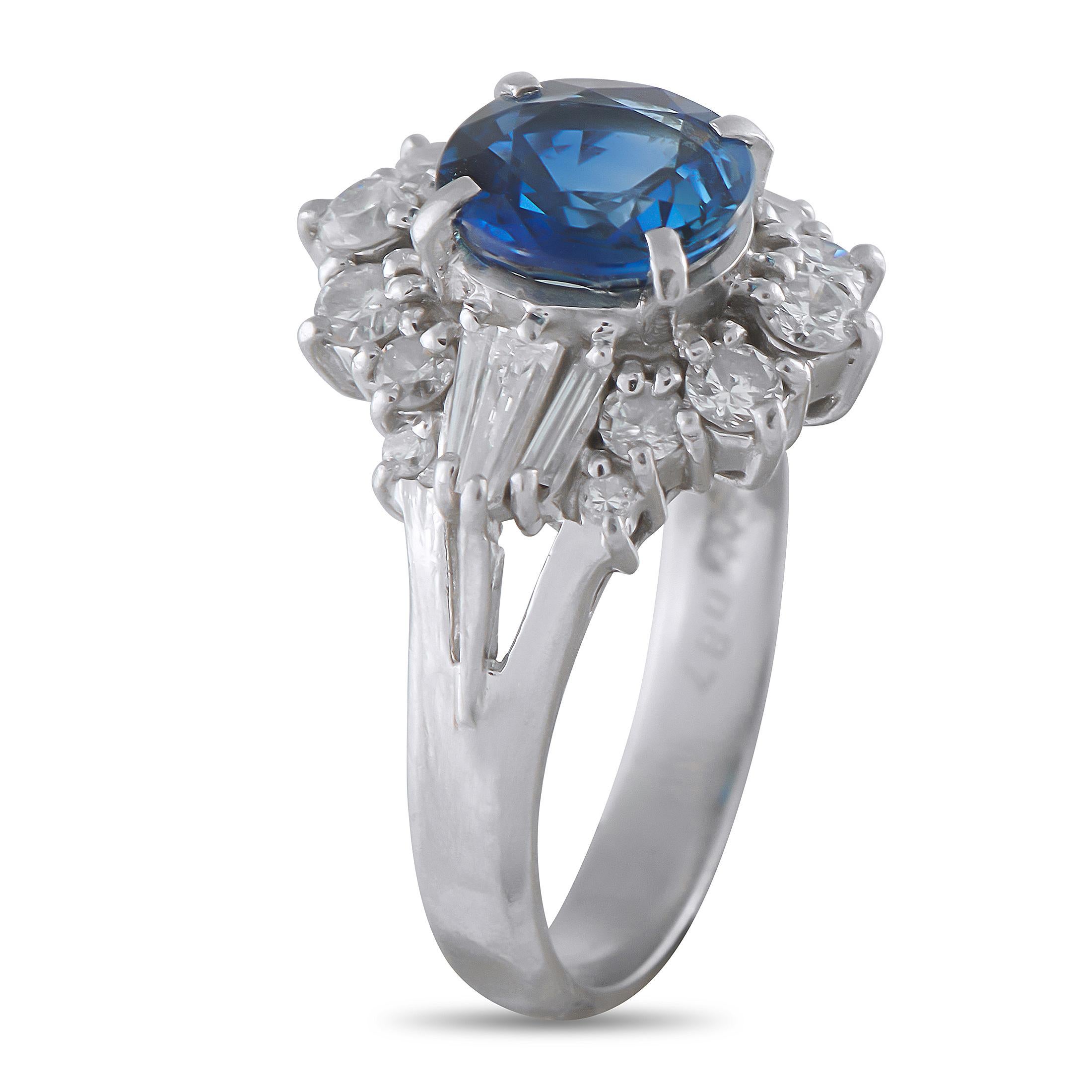 Depth and movement define the beauty of this ring. At its center is a 1.97-carat oval sapphire on four prongs, its rich blue color immediately drawing the eye. Tapered baguette diamonds flank the sapphire, adding linear elegance, while arcs of round