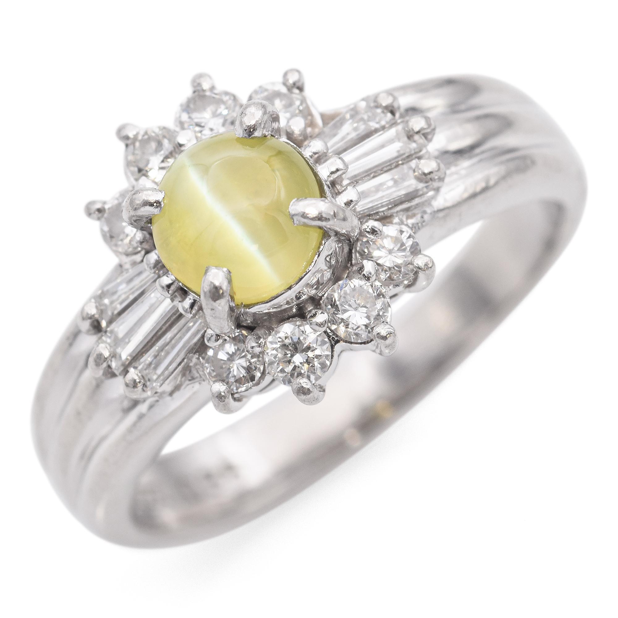This exquisite ring is crafted in platinum. It features a green cat's eye chrysoberyl at the center surrounded by round and tapered baguette white diamonds.

Weight: 5.8 Grams
Stone: Cat's Eye Chrysoberyl 0.88 ct. (5 mm), 0.23 TCW Diamond (0.01-0.02
