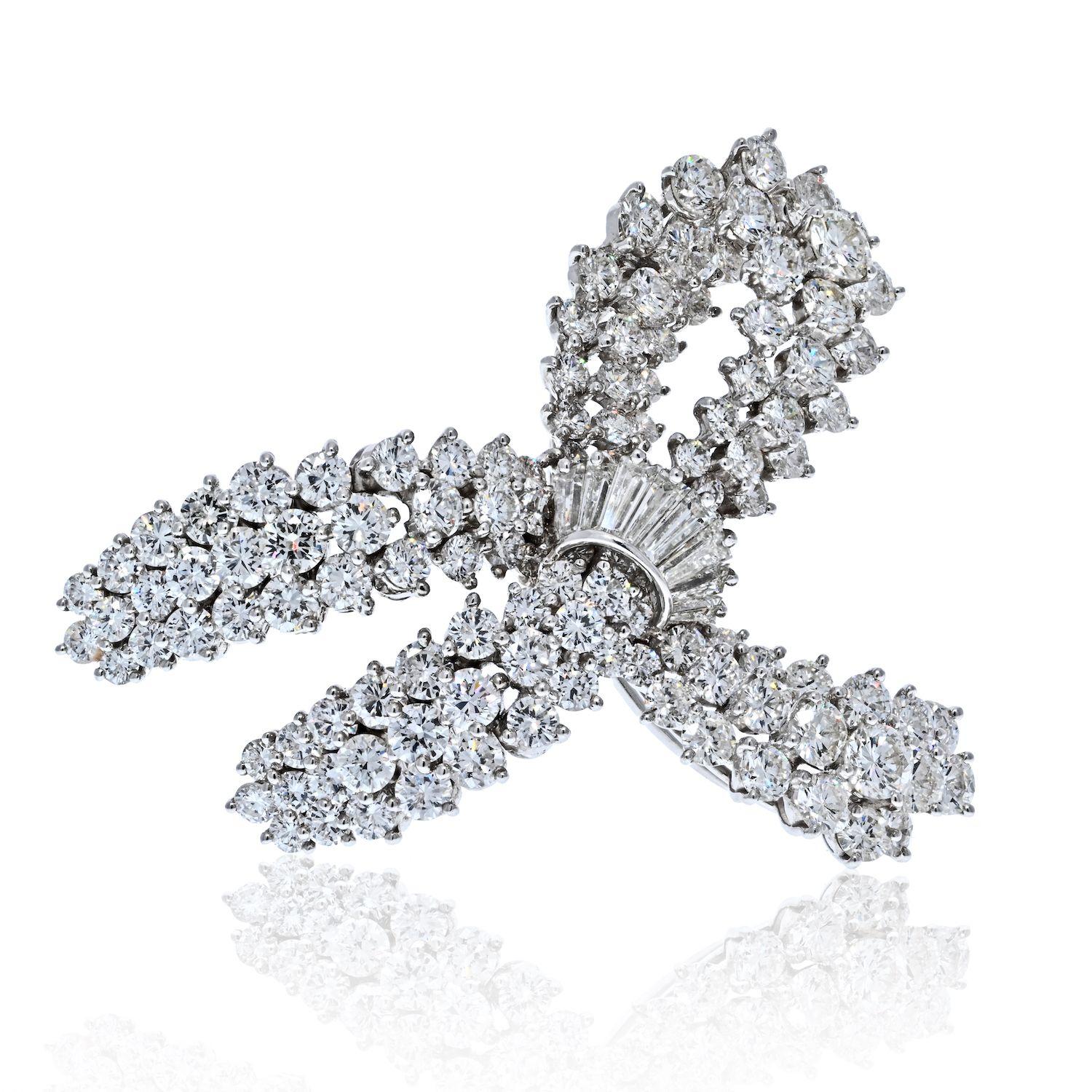 This is a lovely and lustrous diamond bow brooch mounted with round cut diamonds and baguette-cuts of F-G color, VS1-VS2 clarity. Estimated carat weight 10.00cts. This brilliant and gleaming brooch measures about 1.5 inches wide and makes a perfect