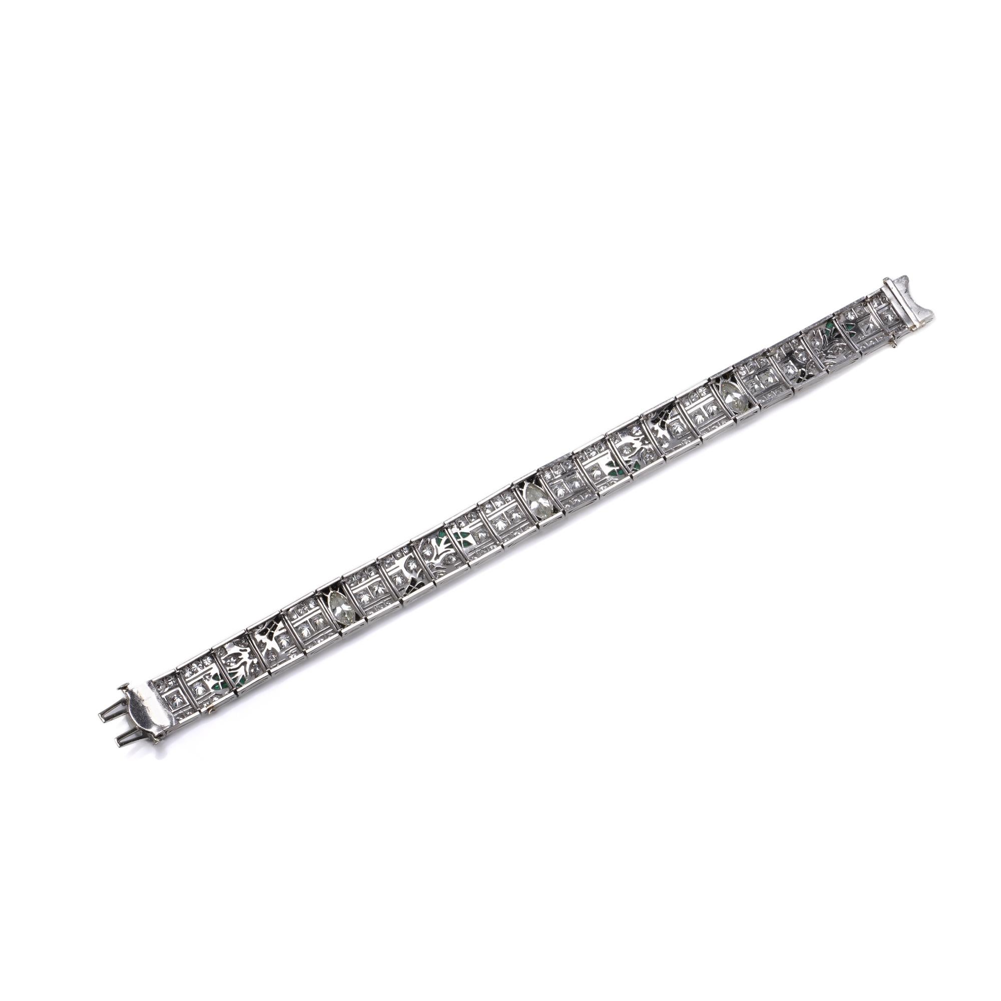 A striking mid-20th century platinum bracelet featuring 145 diamonds of various cuts including marquise and round brilliant, set within geometric panels embellished with onyx borders and stylised foliate motifs set with 36 calibre-cut emeralds.