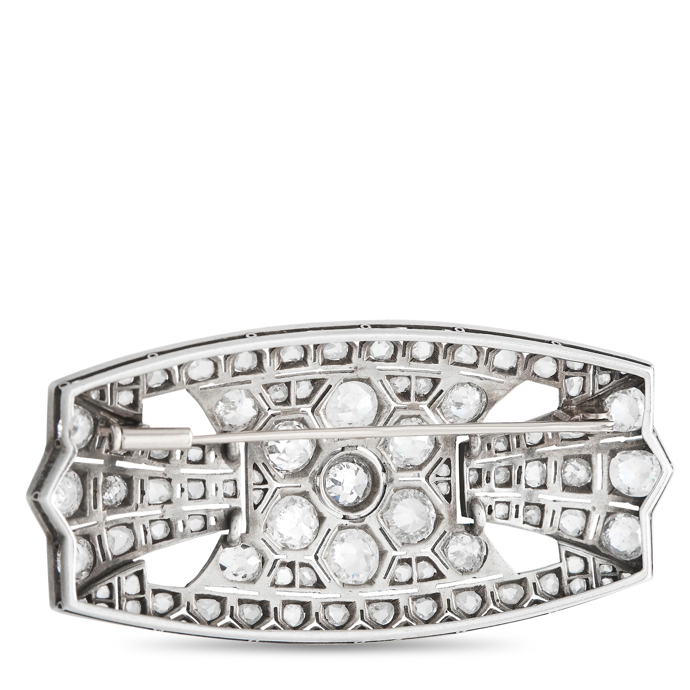 A stunning jewel you'll treasure forever. This brooch is expertly crafted in platinum and features an Art Deco style with 10 carats of diamonds set in a geometric, symmetrical, and streamlined pattern. The brooch boasts a dazzling combination of Old
