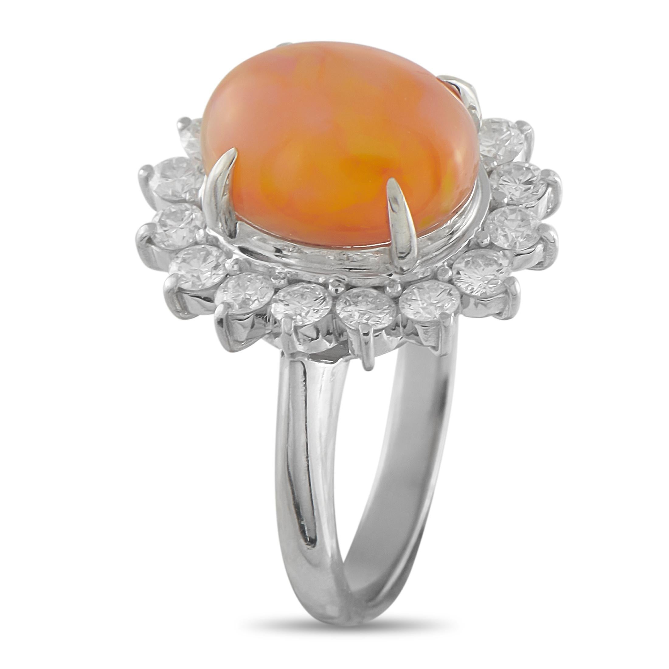Bright, warm, and eye-catching, this ring brings a soft glow to any hand. It features a 4.25-carat yellow-orange opal, its color shifts gently with the light. The gem is held high by four claw prongs and encircled by a sunburst halo of round
