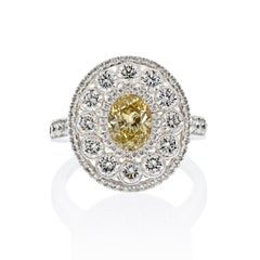 Platinum 1.03ct Oval Cut Diamond Light Fancy Yellow Halo Engagement Ring