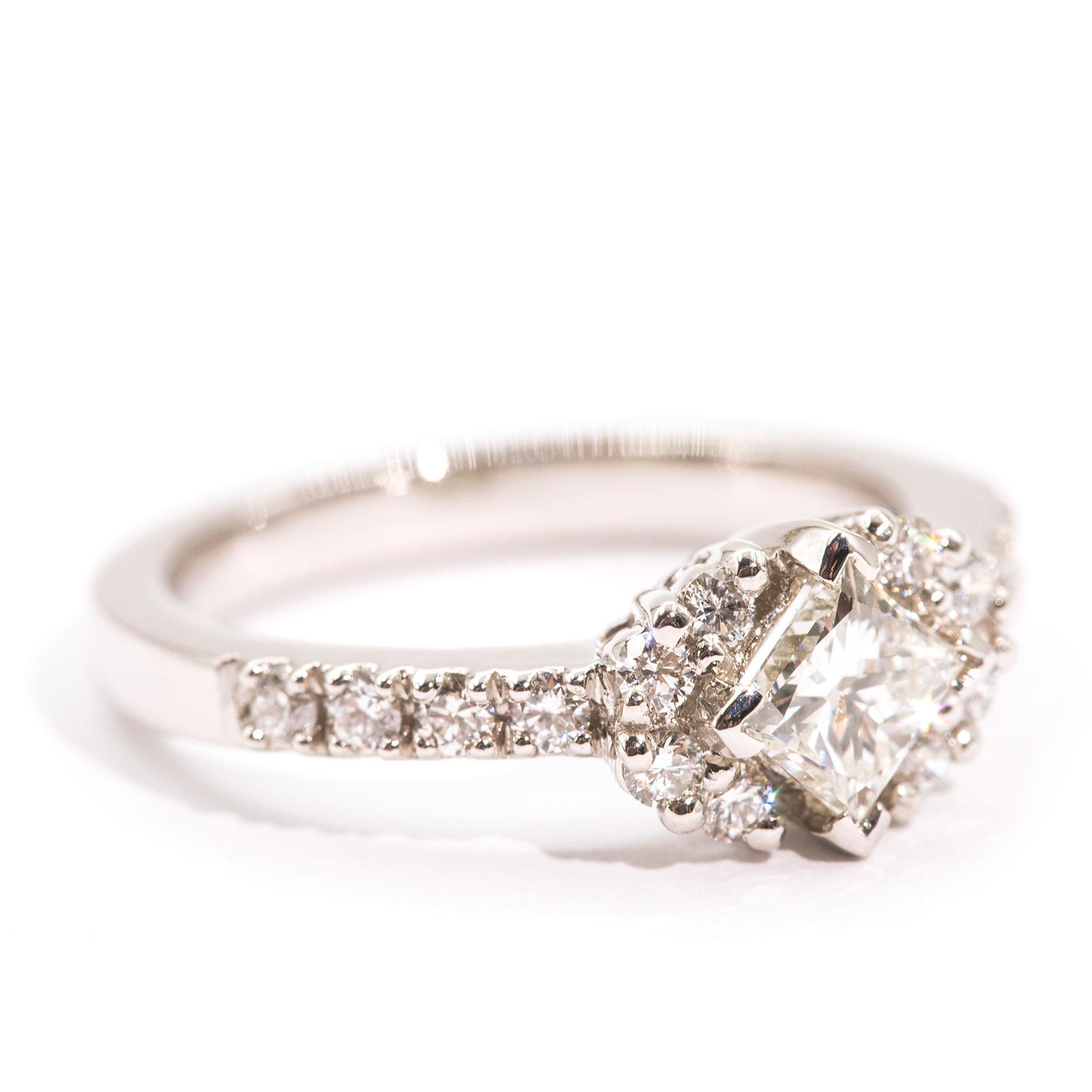 Forged in platinum is this uniquely designed modern engagement ring that features a stunning 0.63 carat certified princess cut diamond in the centre. The princess cut diamond is complimented by carefully set round brilliant cut diamonds that total