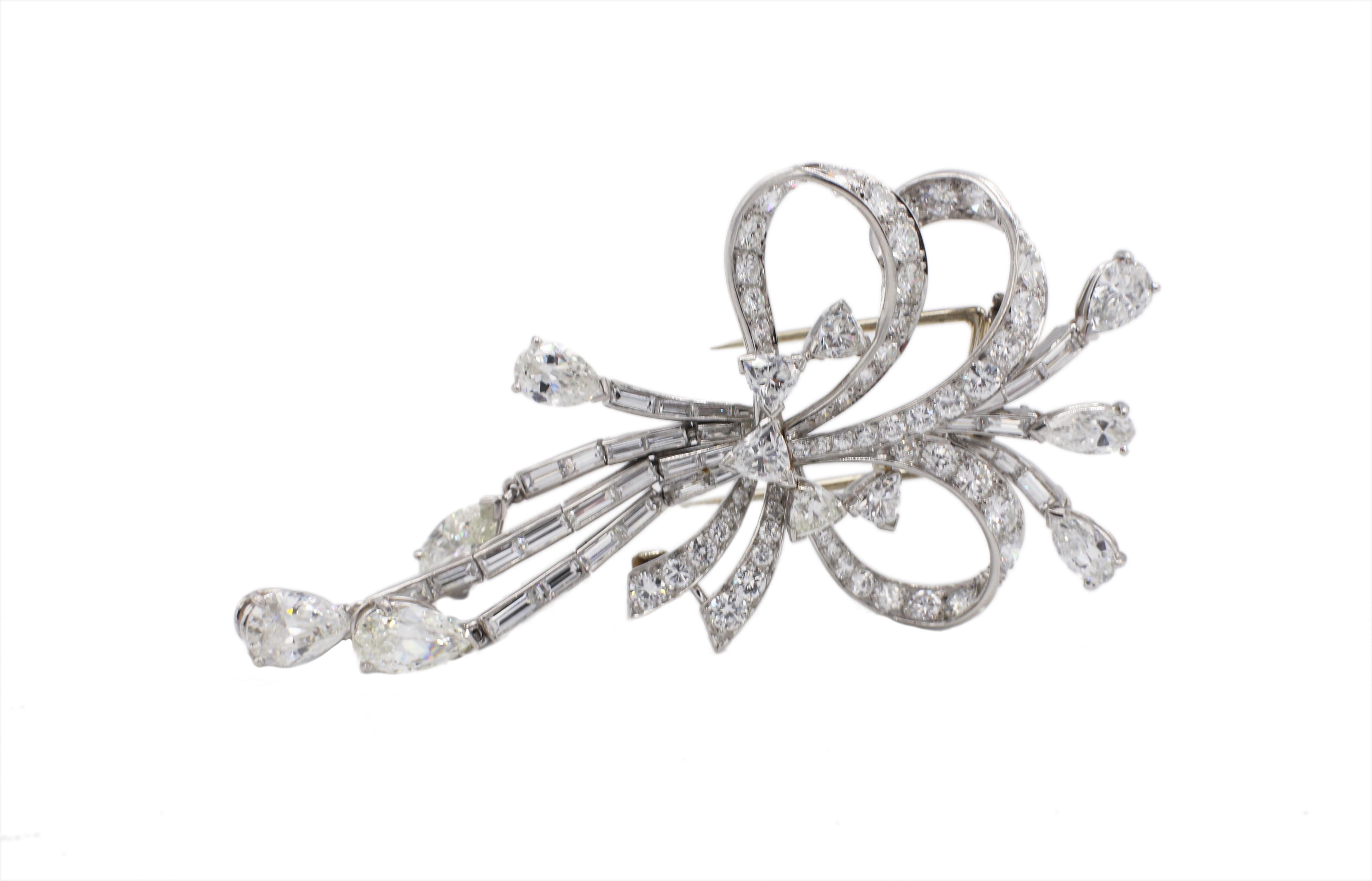 Platinum 10 Carat Diamond Ribbon Bow Brooch Pin 
Metal: Platinum
Weight: 19.37 grams
Diamonds: Approx. 10.50 CTW G-H VS (3.80 pear shapes, 1.50 baguettes, 1.20 trillions, 4.00 round brilliant) 
Length: 2.85 inches
Width: 1.4 inches
