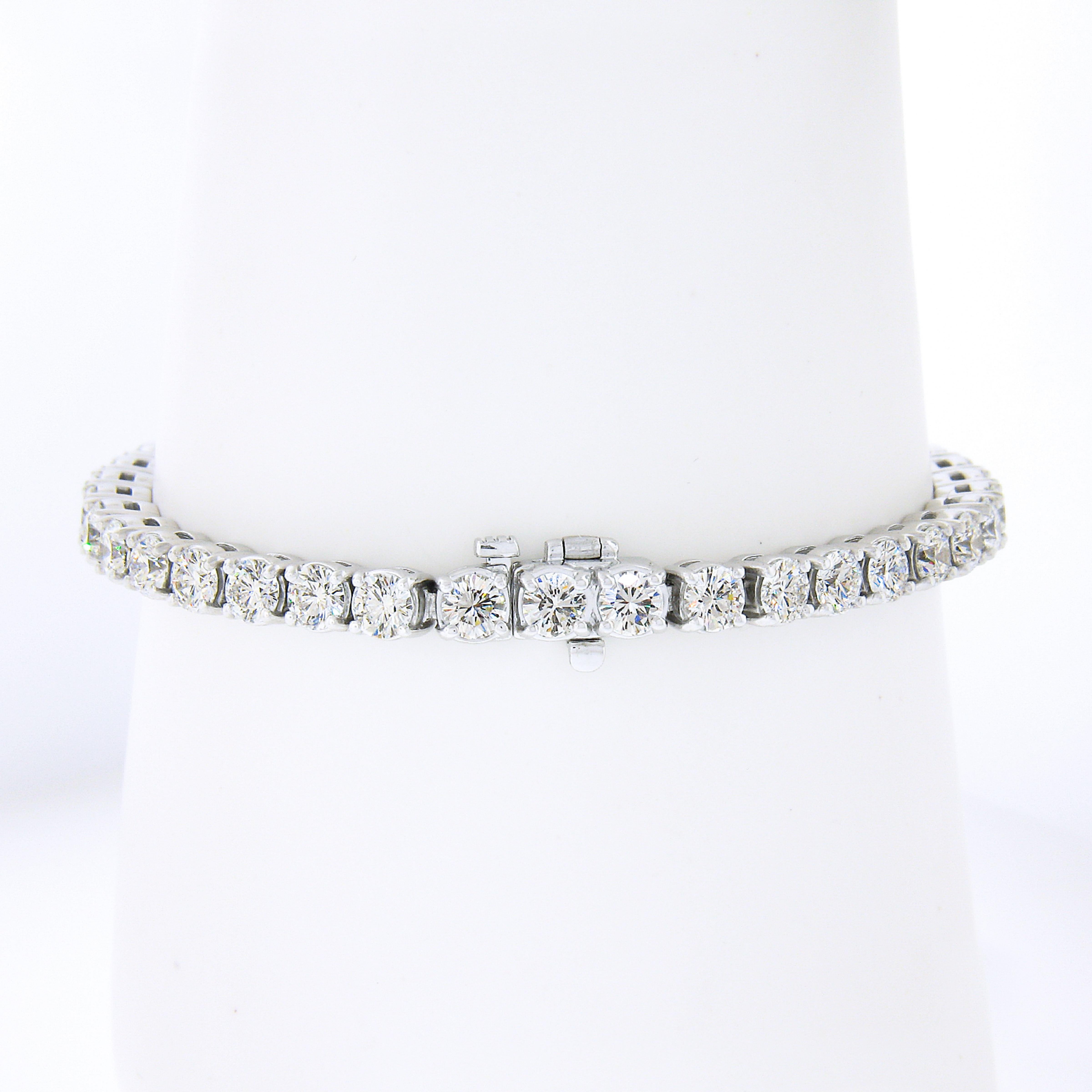 This absolutely jaw dropping and very well made diamond statement tennis bracelet is designed by Badis Jewelers and newly crafted in solid .950 platinum. It is set with 39, TOP QUALITY, and large round brilliant cut diamonds that are mounted in