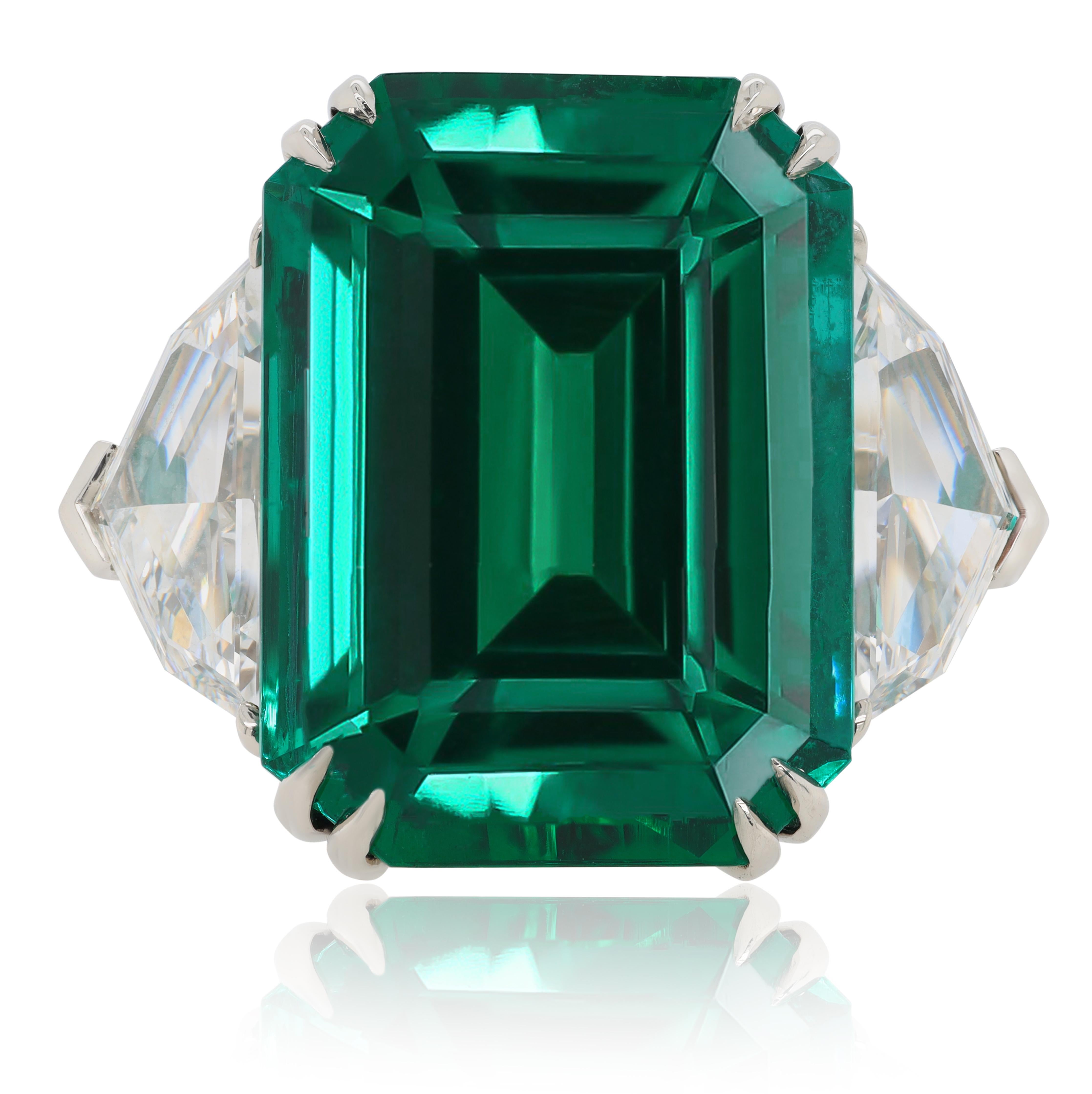 Platinum emerald ring features 11.14 carat of an emerald set in a setting with 1.78cts shiled 2 stone agl certified
