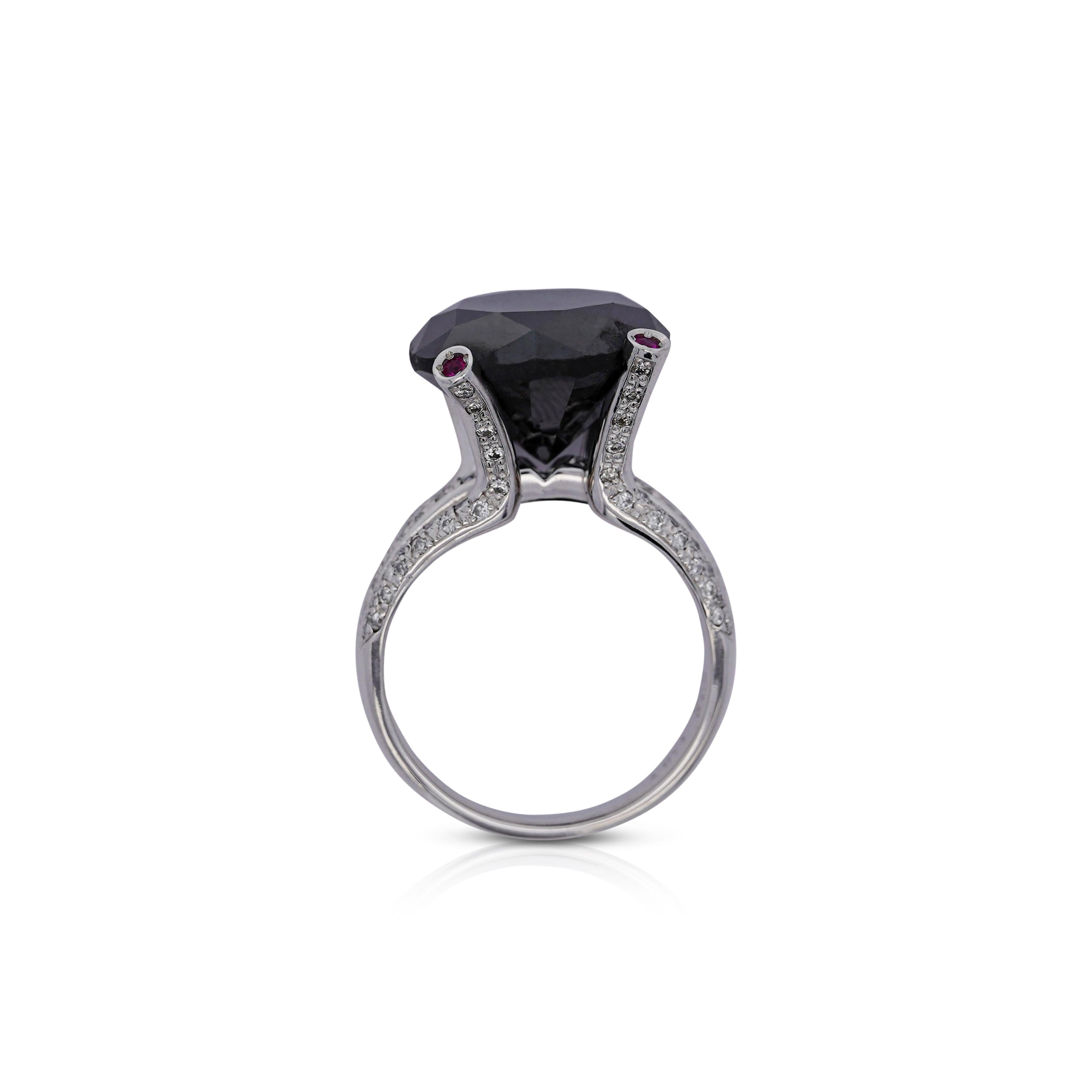 A diamond so bold can say a lot. This platinum ring displays an 11.84 CT round-cut black diamond. This unique stone conveys a strong sense of confidence and elegance. Eighty-four round-cut diamonds, totaling 0.48 CTTW in a channel setting along the