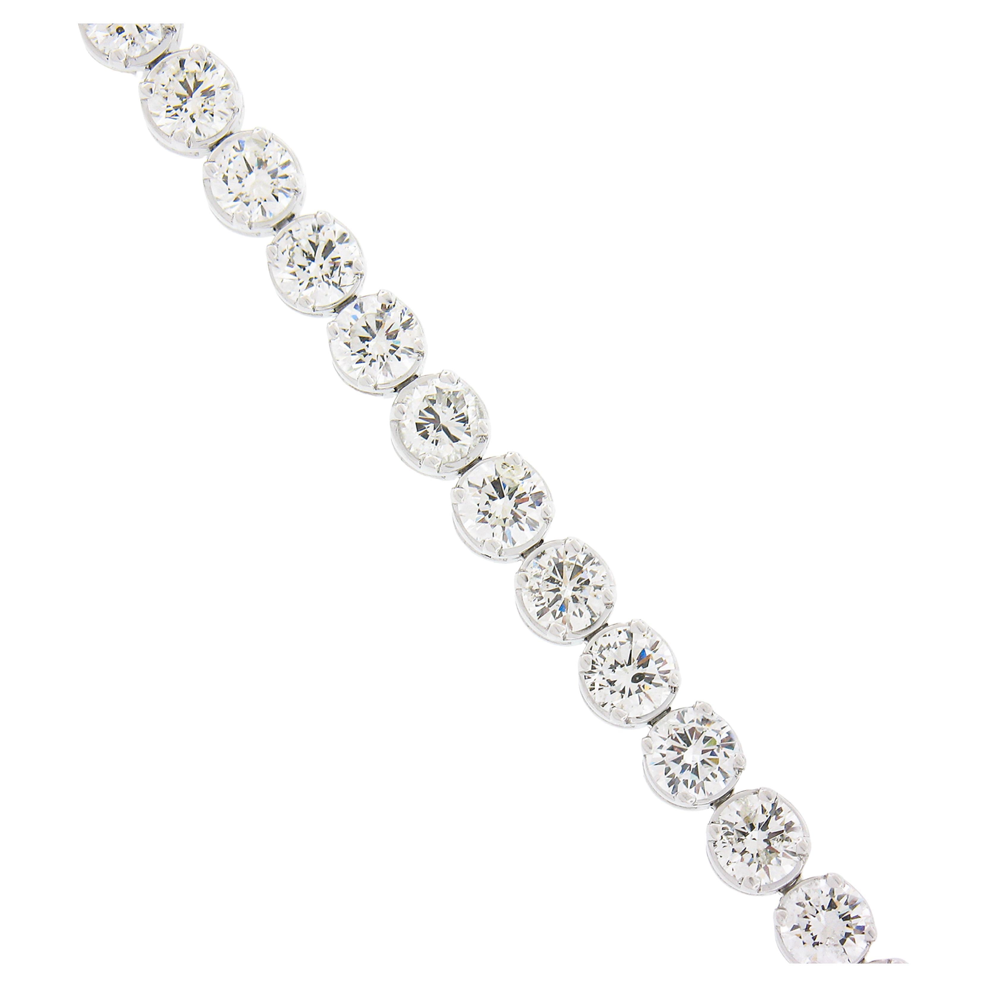 This breathtaking diamond statement tennis bracelet is crafted in solid platinum and set with 34 fine quality and large round brilliant cut diamonds. The diamonds are mounted in solid and sturdy, 4-prong baskets with the most comfortable polished