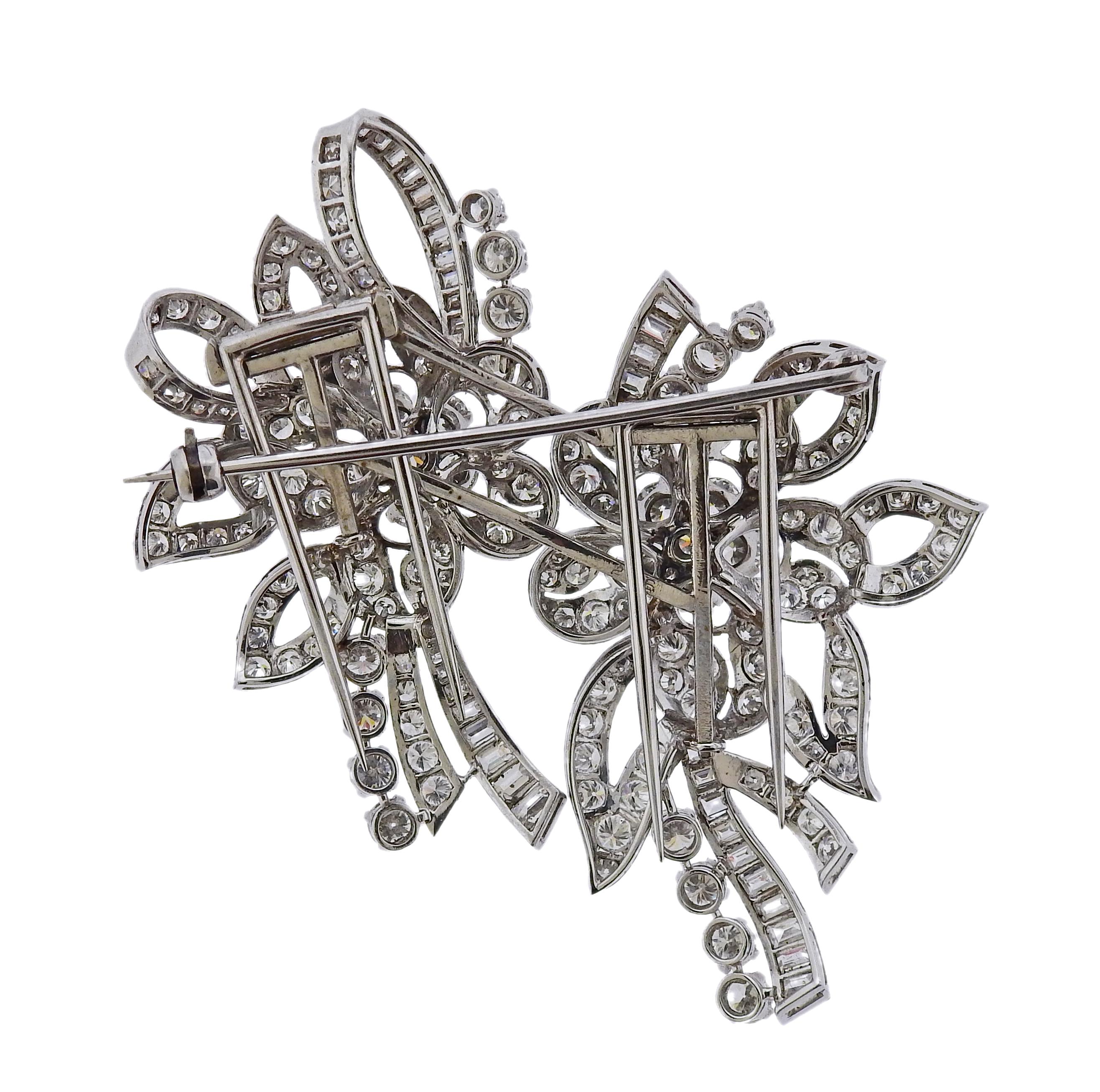 Platinum convertible brooch, turning into two clips, set with a total of approx. 13 carats in VS/GH diamonds. Brooch is 63mm x 52mm, clips measure 52mm x 31mm each. Weight is 29.1 grams. Marked:  2116.