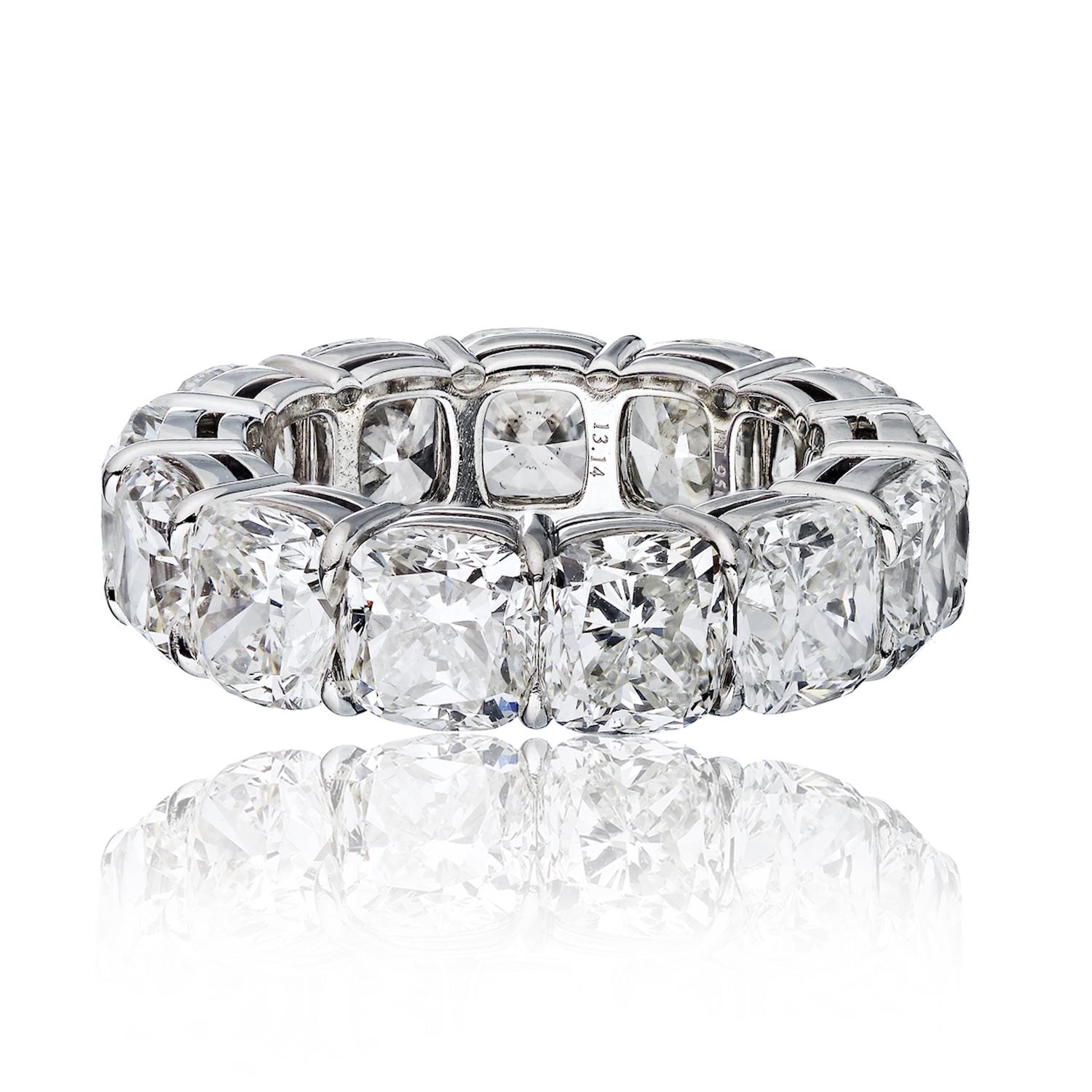 Elevate your style and celebrate love with this stunning diamond eternity band. 

This platinum ring boasts an array of opulent cushion-cut diamonds, each GIA certified for quality and precision. The stones showcase a captivating range of G to H