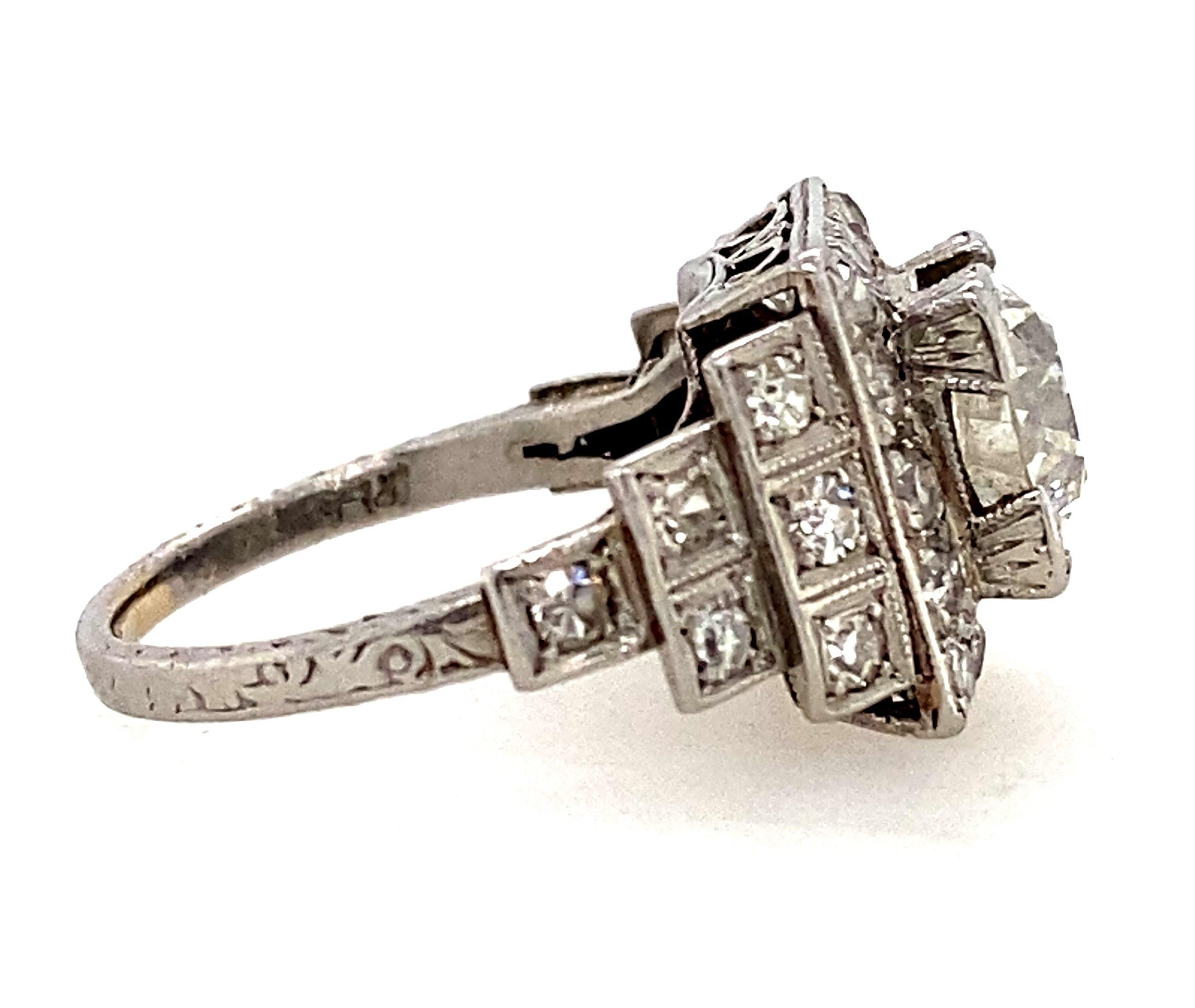 Hailing from the roaring twenties, this stunning original platinum, circa 1920s-30s, Art Deco engagement ring features diamond pave-set steps leading to a scintillating 1.32 carat center old European-cut diamond; the ring is accented with single-cut