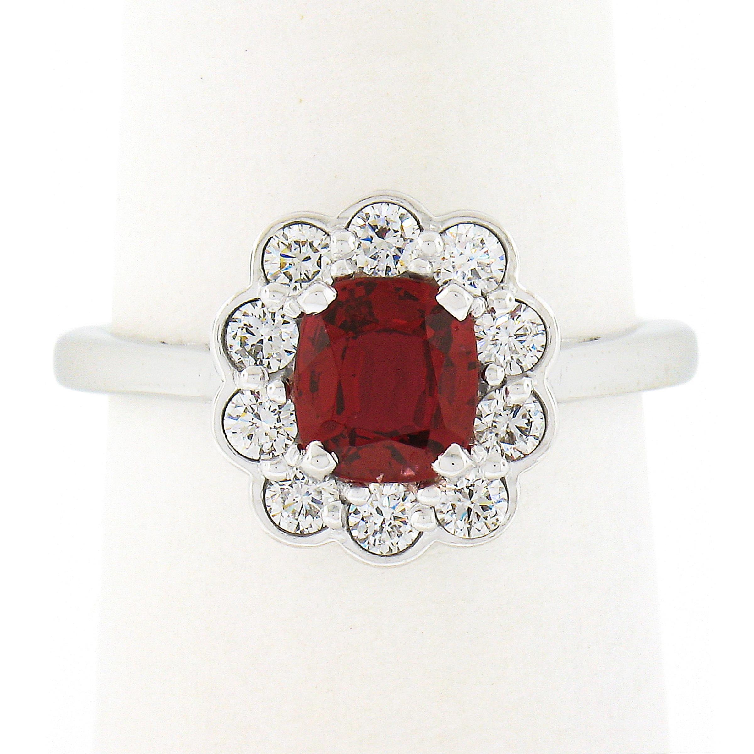 This truly breathtaking custom made ring is newly crafted from solid platinum. It features an elegant flower cluster design set with a, GIA certified, natural spinel stone at its center. This gorgeous gemstone has a cushion brilliant cut and