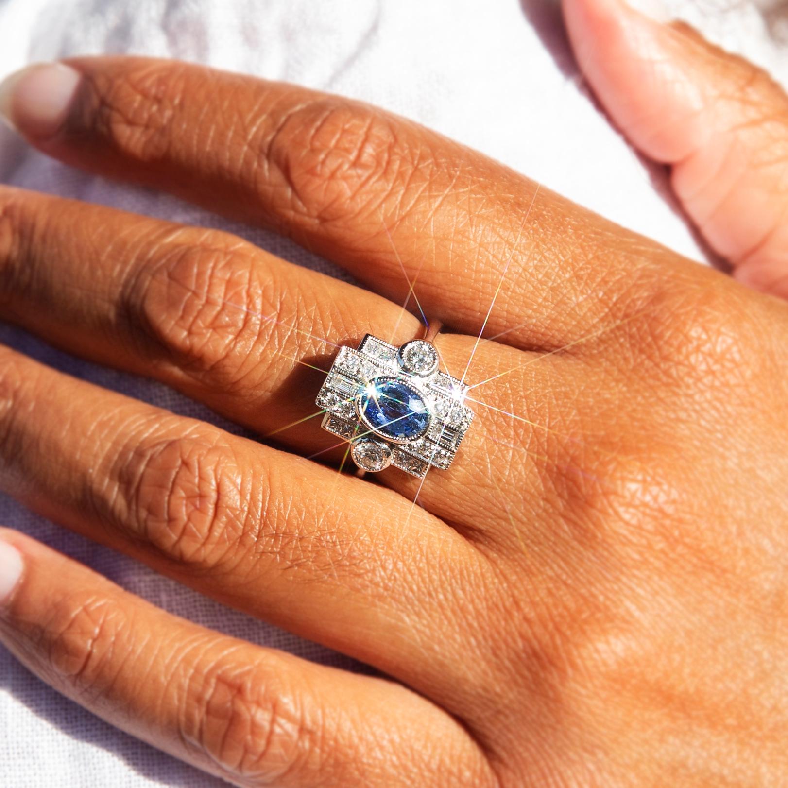 Lovingly recreated in gleaming platinum, this Art deco-inspired contemporary ring features an alluring 1.36-carat natural bright blue Ceylon-type sapphire and is encompassed by 0.71 carats of bright shimmering round brilliant cut diamonds,