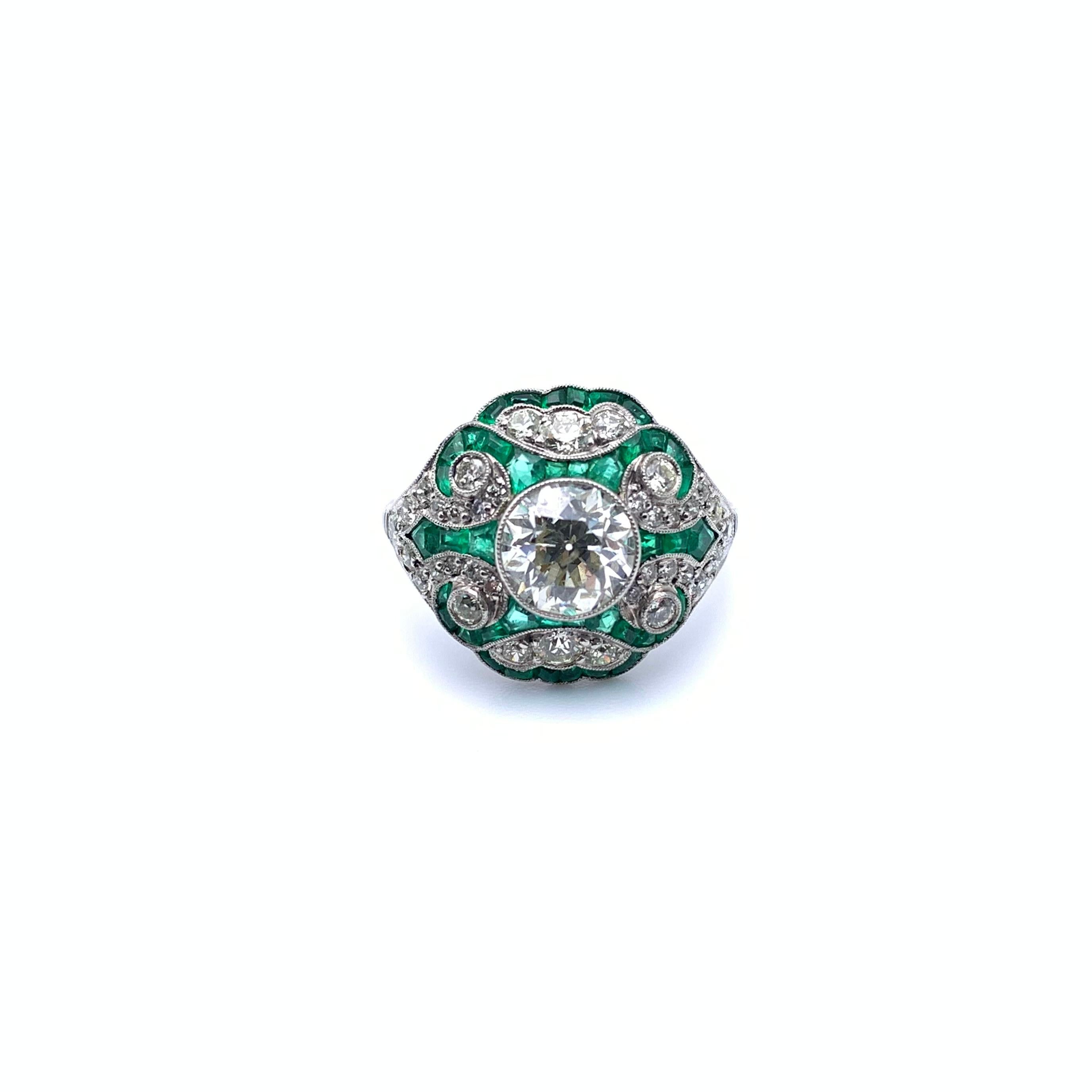 This gorgeous, Art-Deco-inspired ring is set in platinum. The center stone is an Old European-cut diamond in a bezel setting with traditional milgrain detailing. The stone weighs 1.49 carats, grades I1 in clarity, and I in color. It is surrounded by