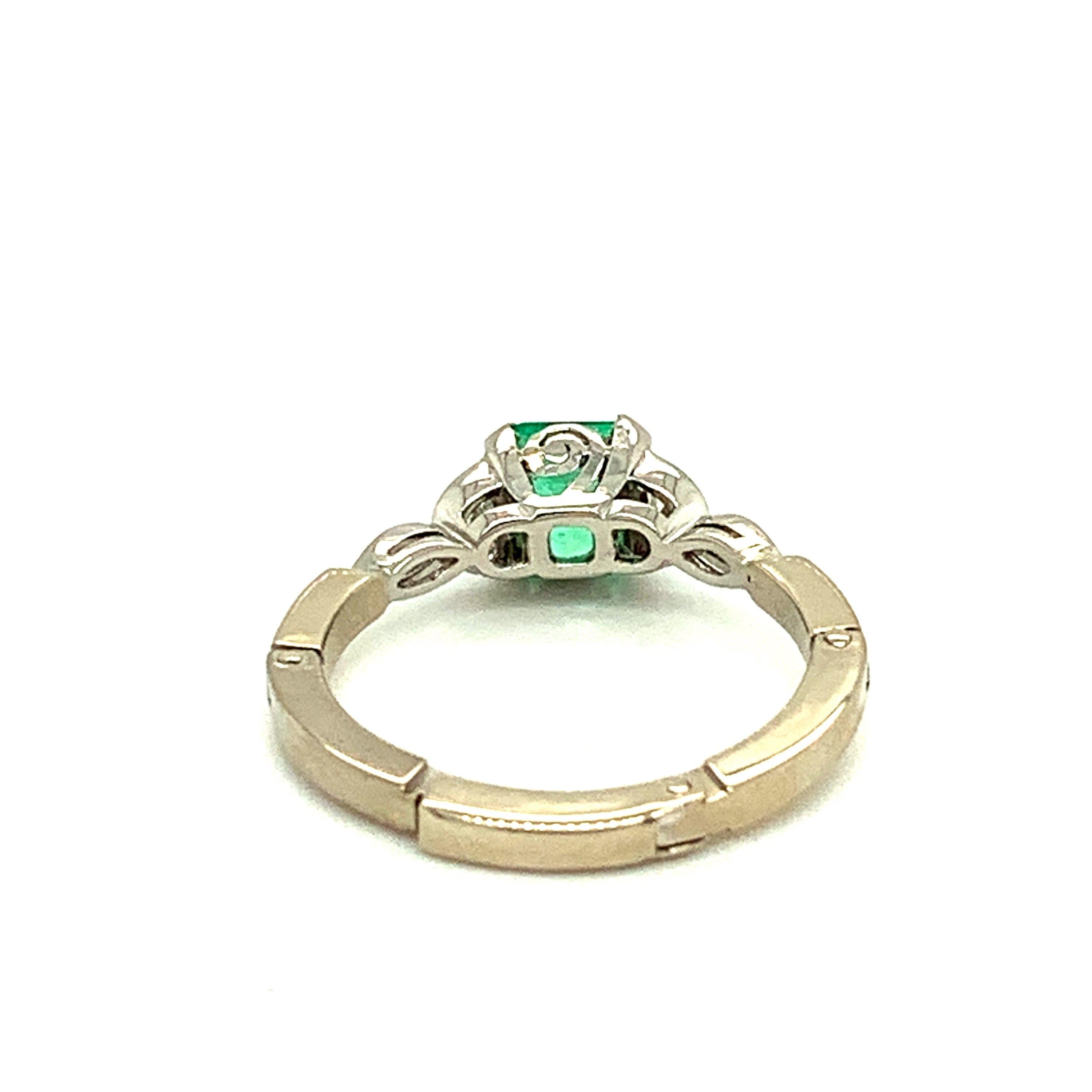 Platinum 14k Gold .81ct Genuine Natural Emerald and Diamond Ring (#J4798)

Emerald and diamond ring featuring a bright grass green emerald weighing .81cts and measuring about 5mm square. The emerald is accented by a pair of half moon diamonds