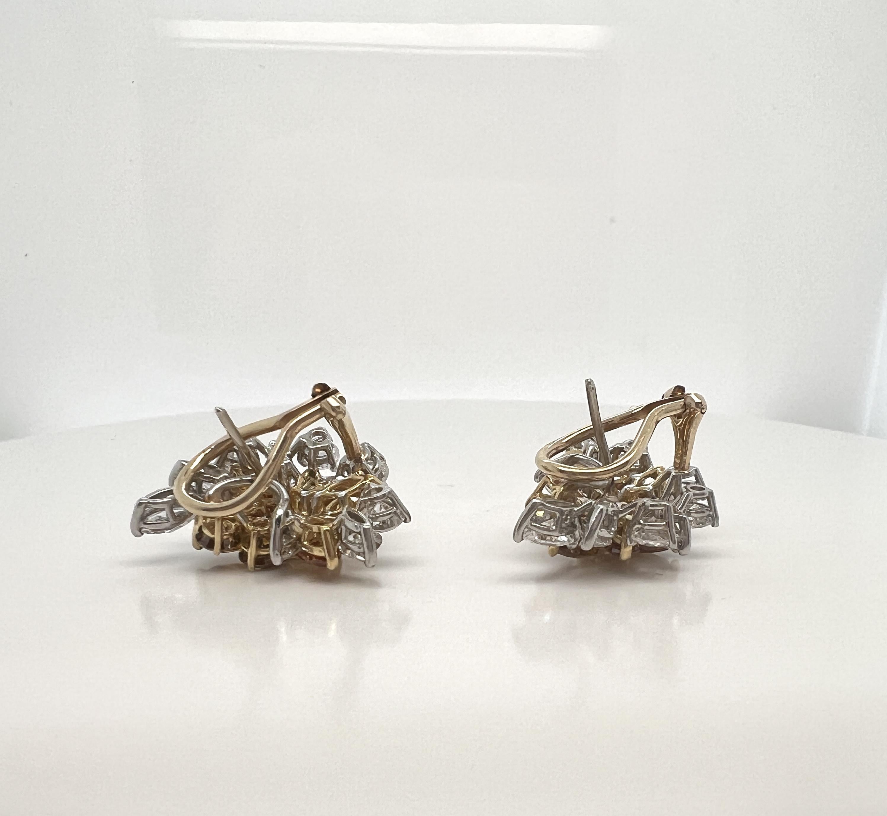 Platinum, 14k Gold, Colored Diamond, and Diamond Earrings.

The spray-form earrings each centering a cluster of marquise-, pear-, and round brilliant-cut orangish-yellow diamonds framed by marquise- and round brilliant-cut diamonds; diamonds