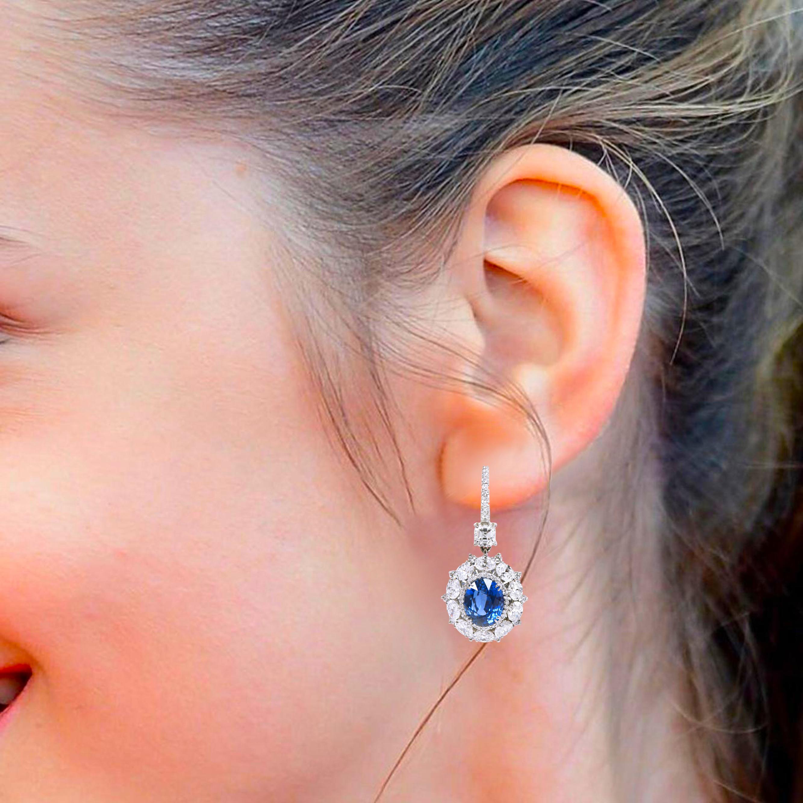 Platinum 15.23 Carats Solitaire Diamond and Blue Sapphire Cocktail Earrings

Mesmerizing, modest, and ethereal, this eclectic pair of earrings have a wear-forever power. Hanging from a  classic hoop of pavè diamonds, encrusted with a diamond that