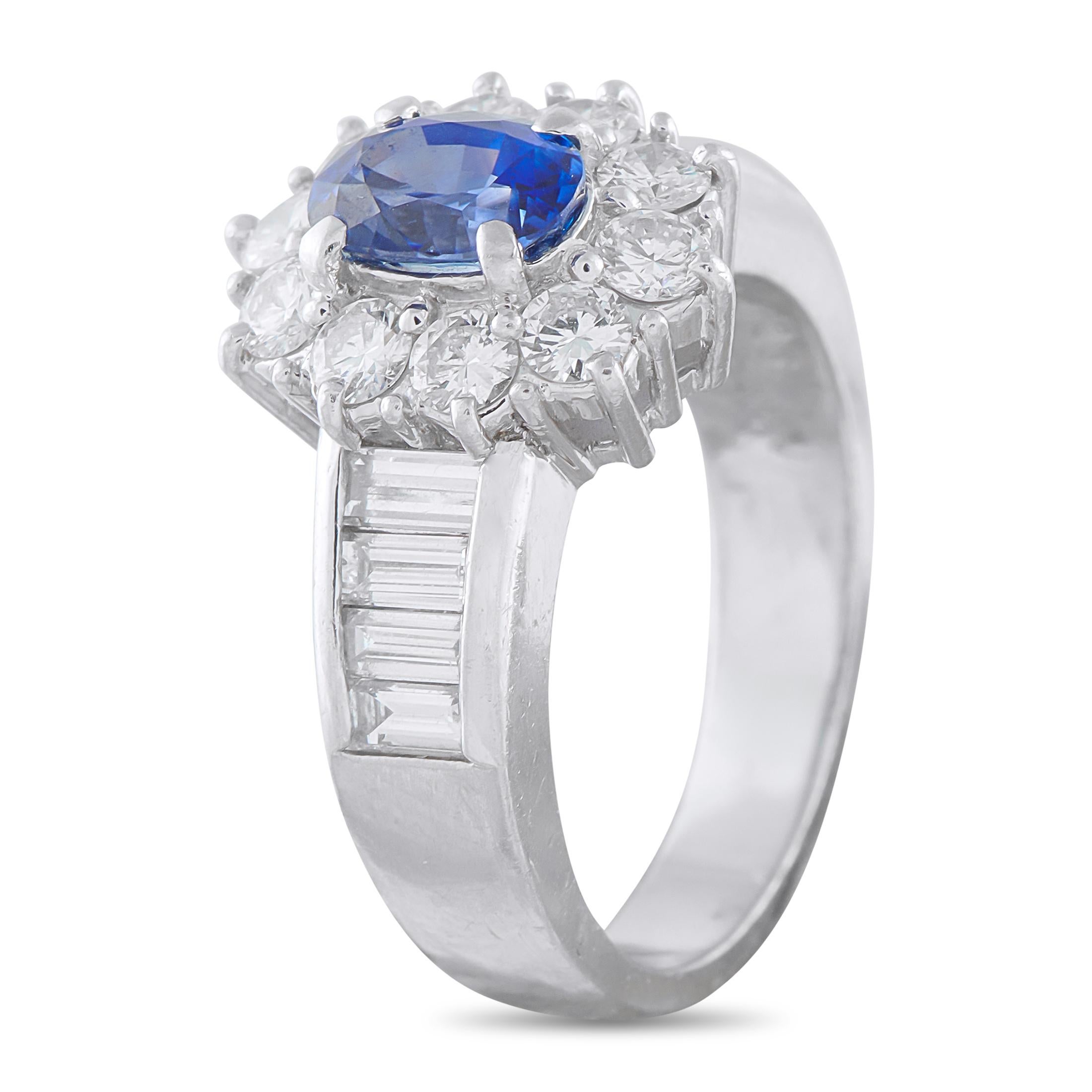 This ring focuses on a 1.26-carat oval sapphire, its deep color held aloft by four prongs that maximize its light exposure. The blue gem is perfectly encircled by a fine halo of brilliant round diamonds, lending the centerpiece a soft glow and a