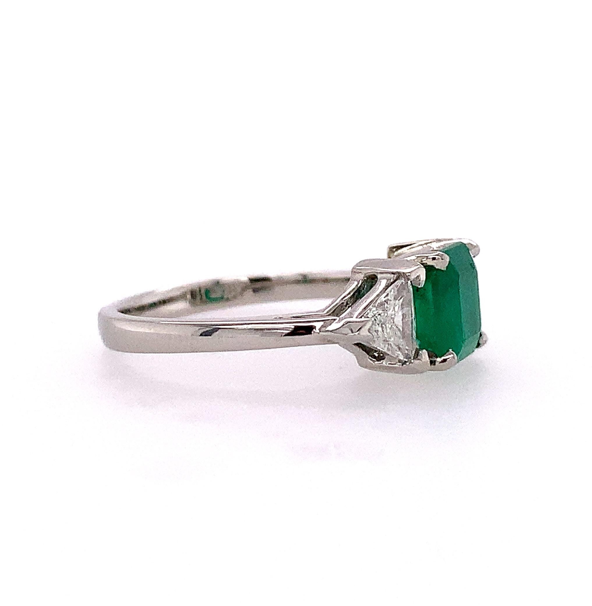  Platinum emerald & diamond ring featuring a genuine earth mined emerald cut emerald weighing 1.30 carats. The emerald has A report from the Colombian Gem Lab stating natural Emerald from Colombia. The emerald has bright grass green color and