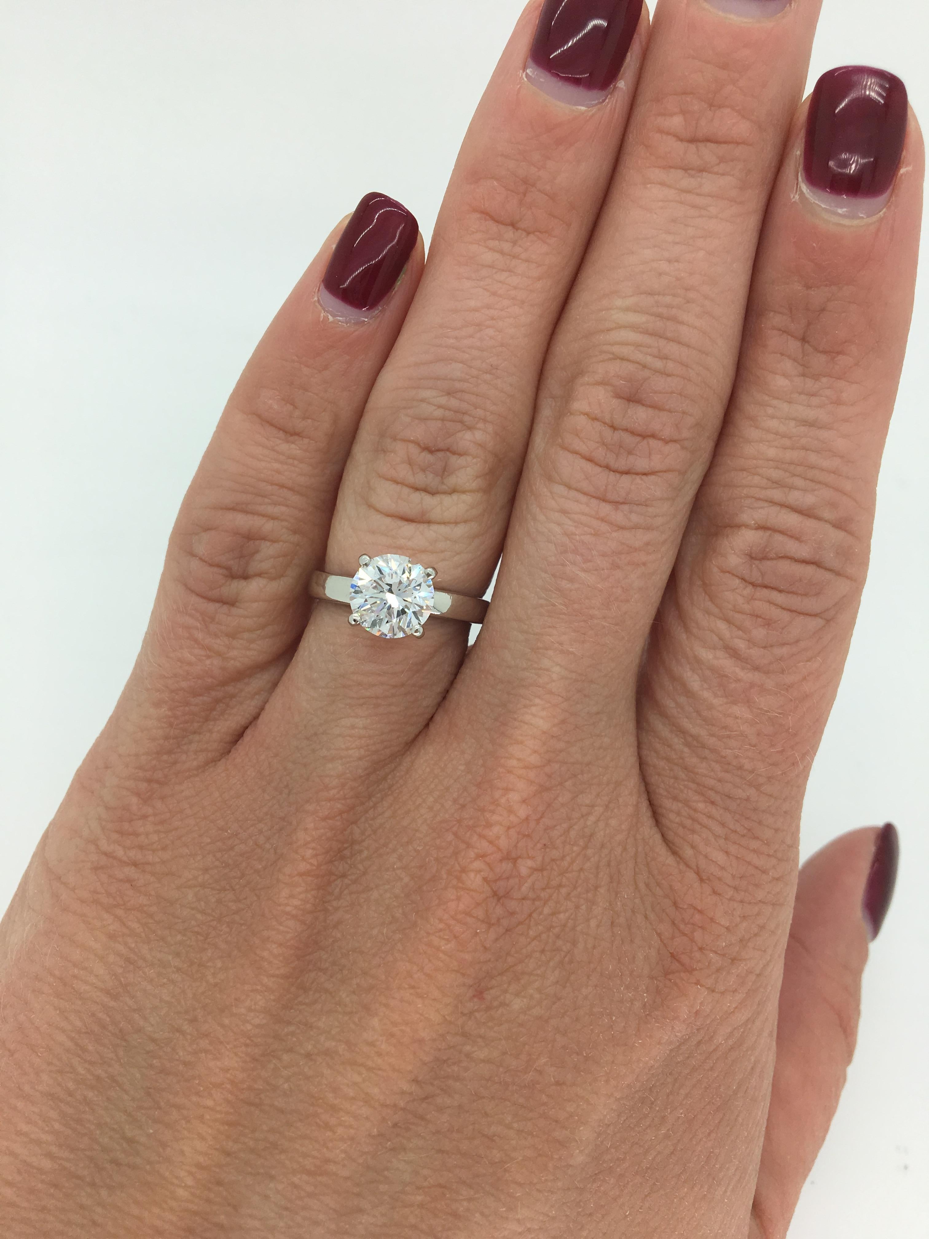 This beautiful engagement ring features a 1.61CT Round Brilliant Cut Diamond set in a Platinum solitaire ring. The featured diamond displays E color and SI1 clarity.  The ring is currently a size 5 and weighs 5.1 grams. The band is stamped PLAT to