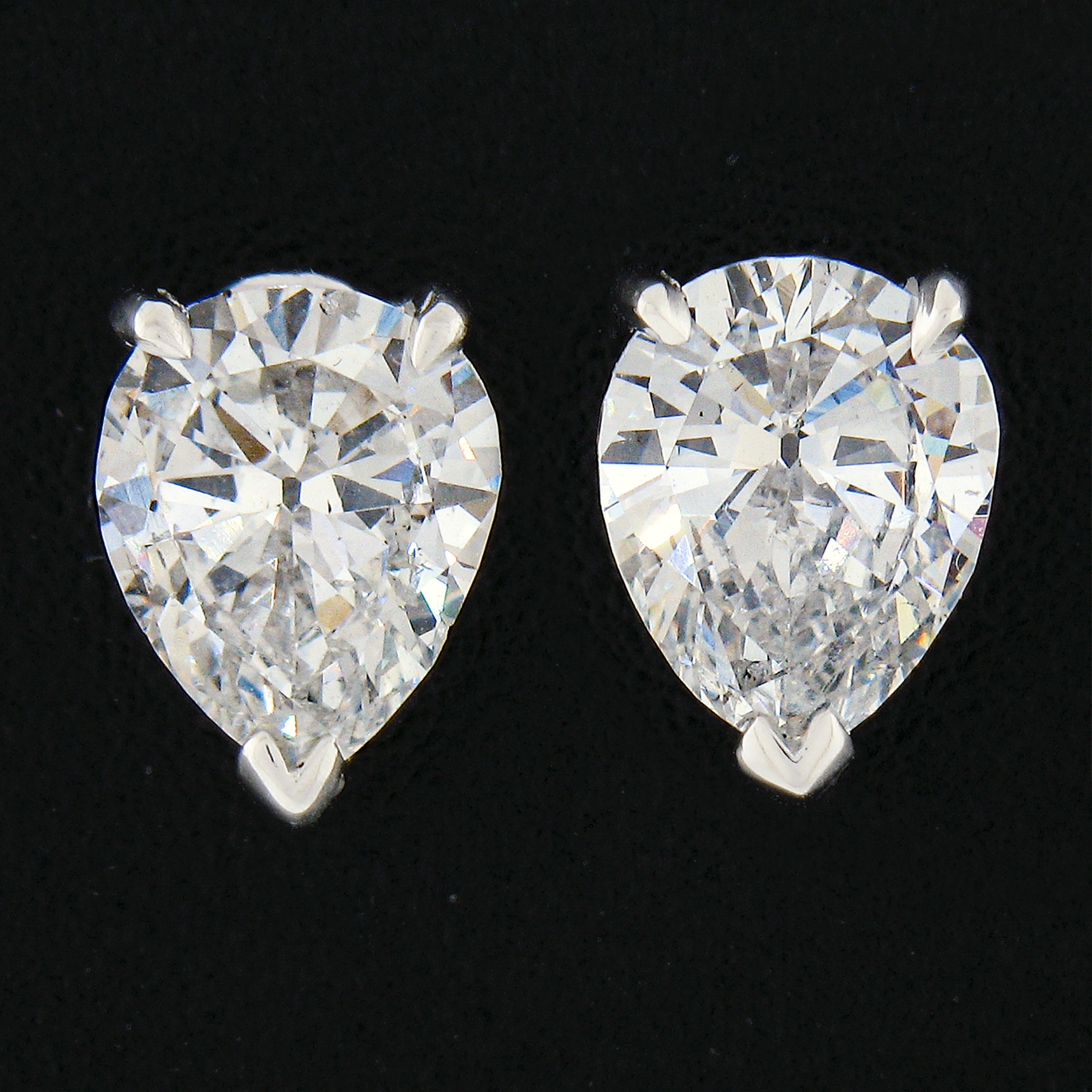 This stunning pair of diamond stud earrings was newly crafted from solid 950 platinum and features two exceptionally brilliant and fiery GIA certified OLD CUT pear brilliant diamonds. The diamonds total exactly 1.69 carats in weight with colorless