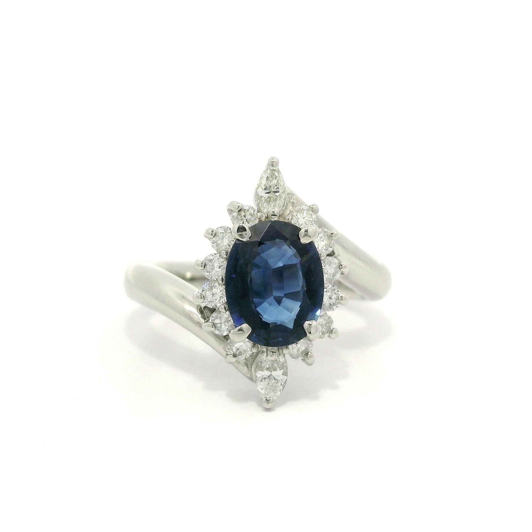 Anello in platino con zaffiro blu reale ovale da 1,71 carati e diamante a raggiera con design bypass
