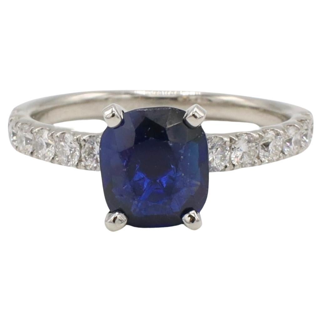Platinum 1.76 Carat Natural Blue Sapphire & Diamond Accented Engagement Ring 
Metal: Platinum
Weight: 3.95 grams
Sapphire: 1.76 carats, cushion natural blue sapphire 7.1 x 6.4mm
Diamonds: Approx. 0.36 CTW G VS round natural diamonds
Size: 5 (US)

