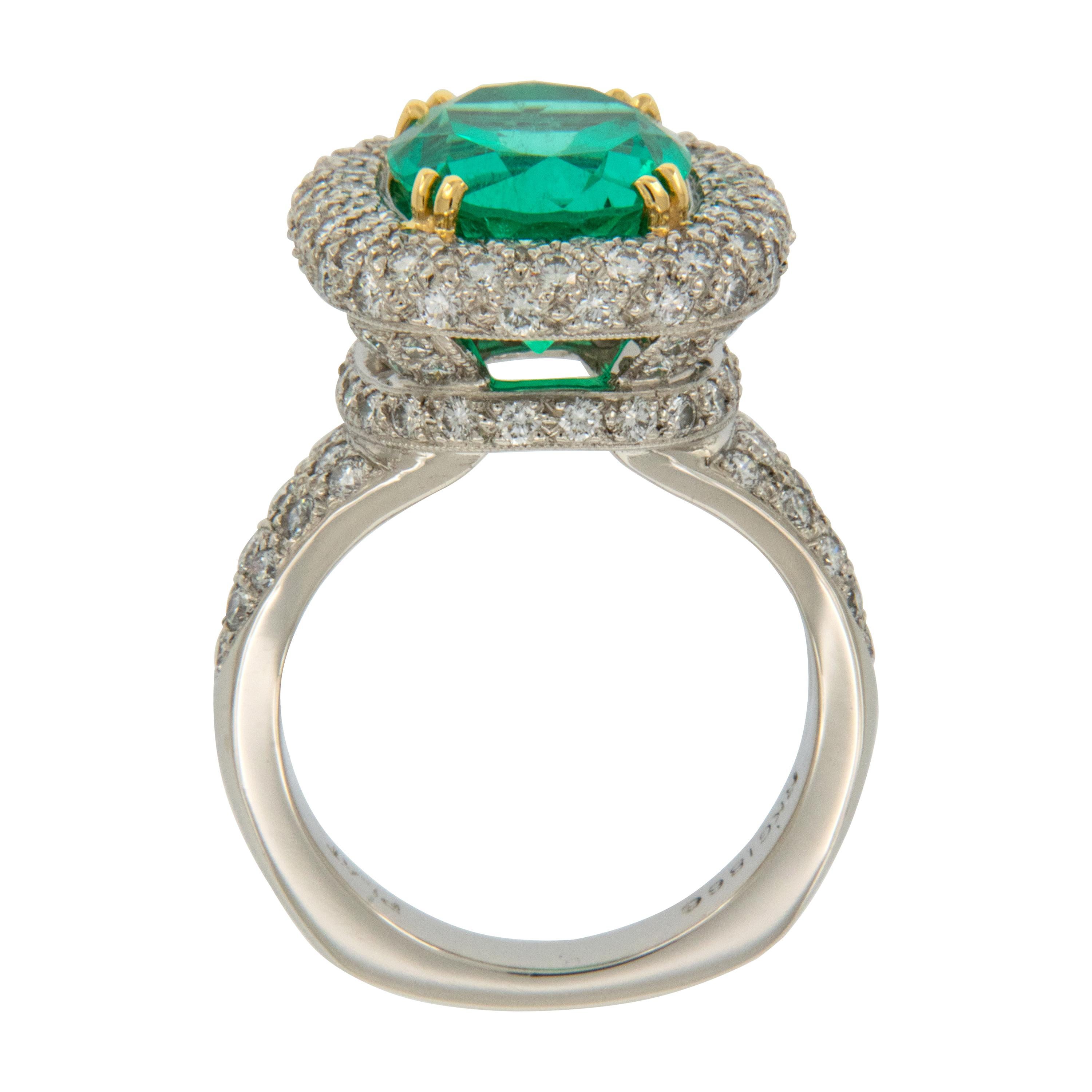 This stunning ring showcases a lively, extraordinarily clean 4.00 carat emerald of exceptional bluish green color. Surrounding the emerald are 2.00 Cttw of pave' set fine quality diamonds (F-G, VS) - all in a custom made ring with European shank.