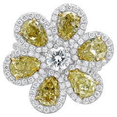 Platinum 
18 Karat Yellow Gold Fancy Yellow Pear Diamond 
White Diamond Ring